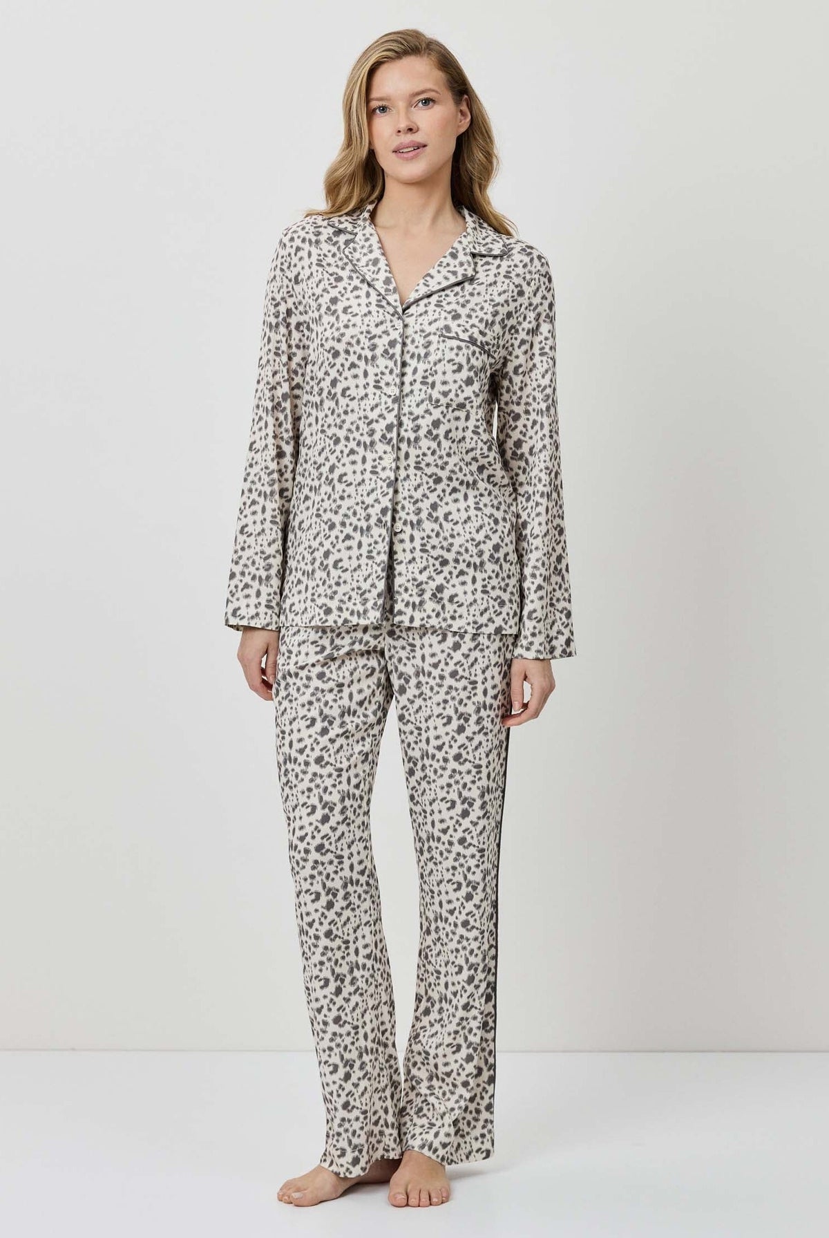 Woman wearing a patterned pajama set on a white background
