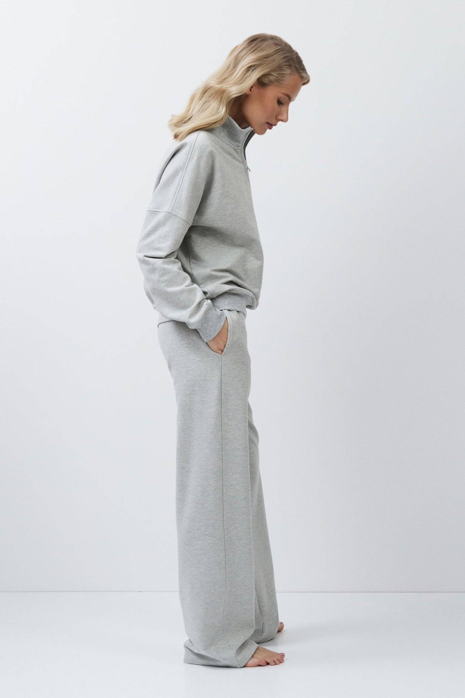 Woman wearing a gray outfit on a white background