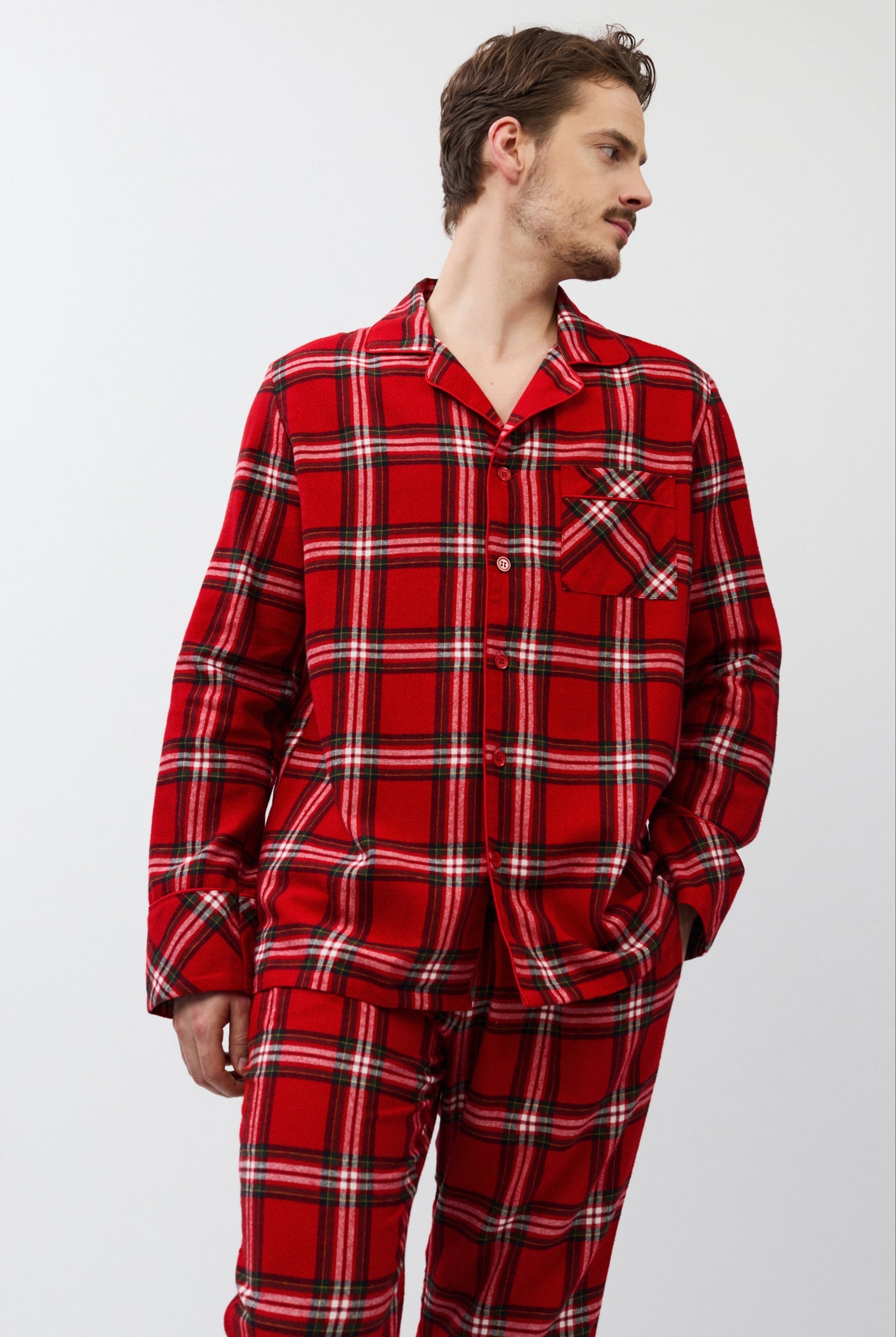 Man wearing red plaid pajamas on a white background