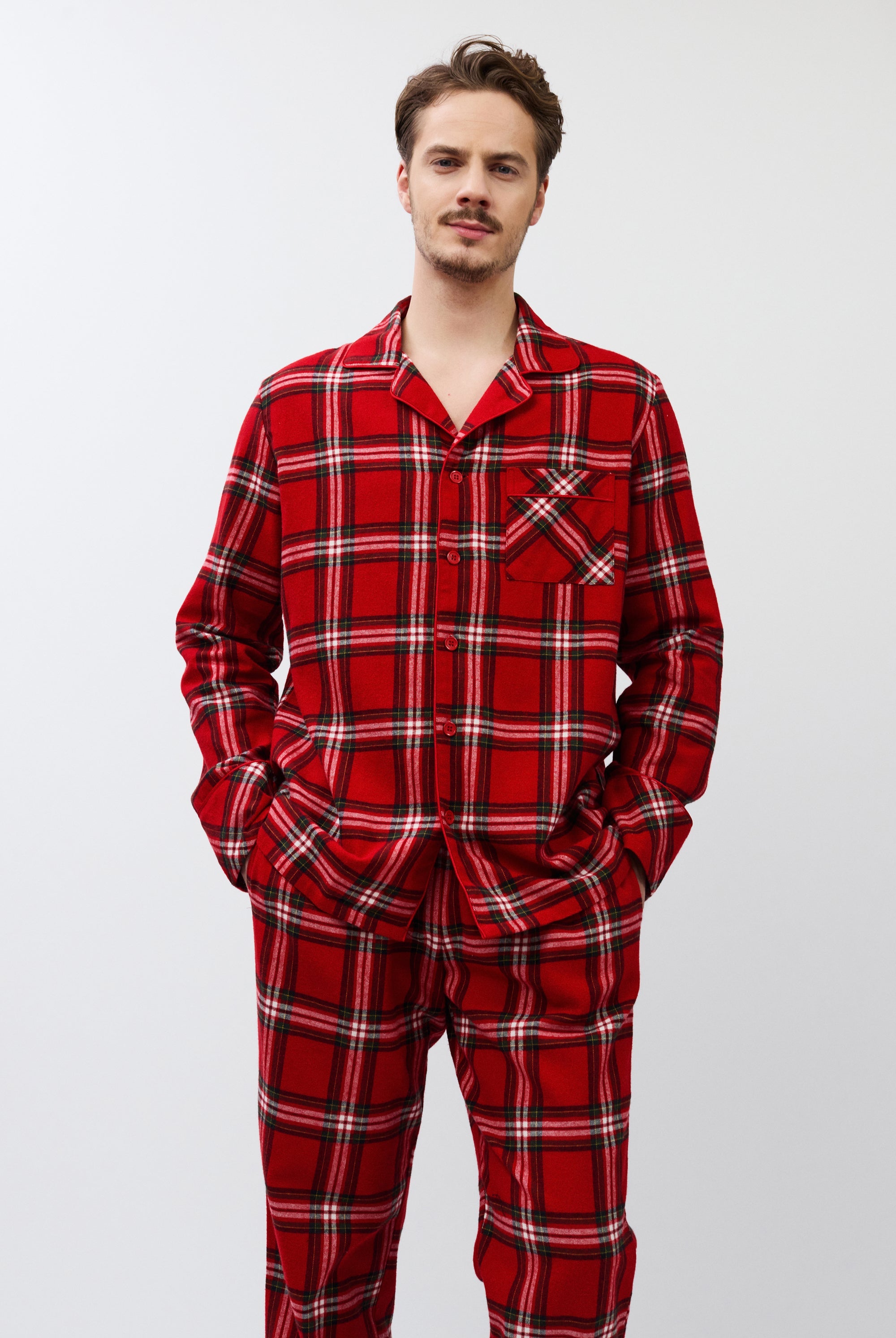 Man wearing red plaid pajamas on a white background