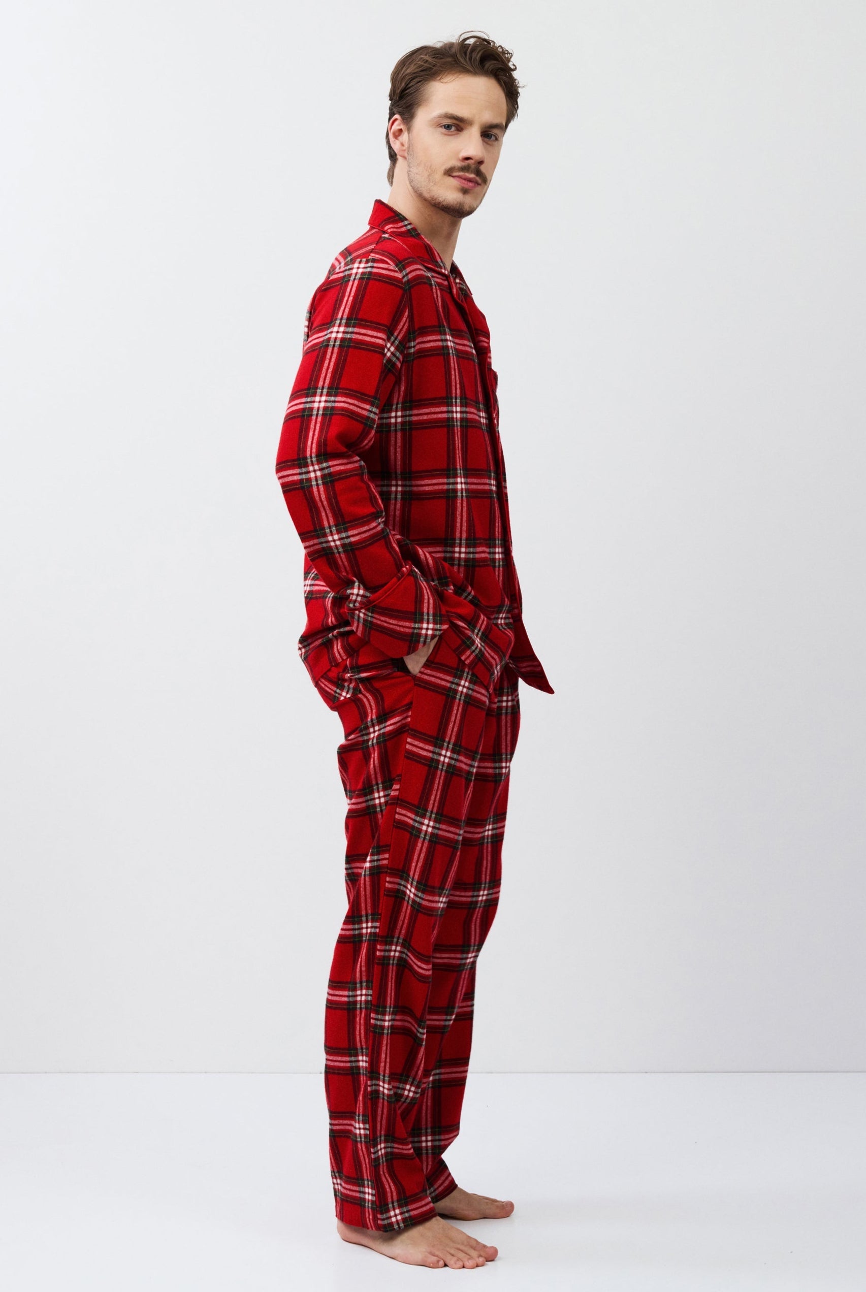 Man wearing red plaid pajamas on a white background