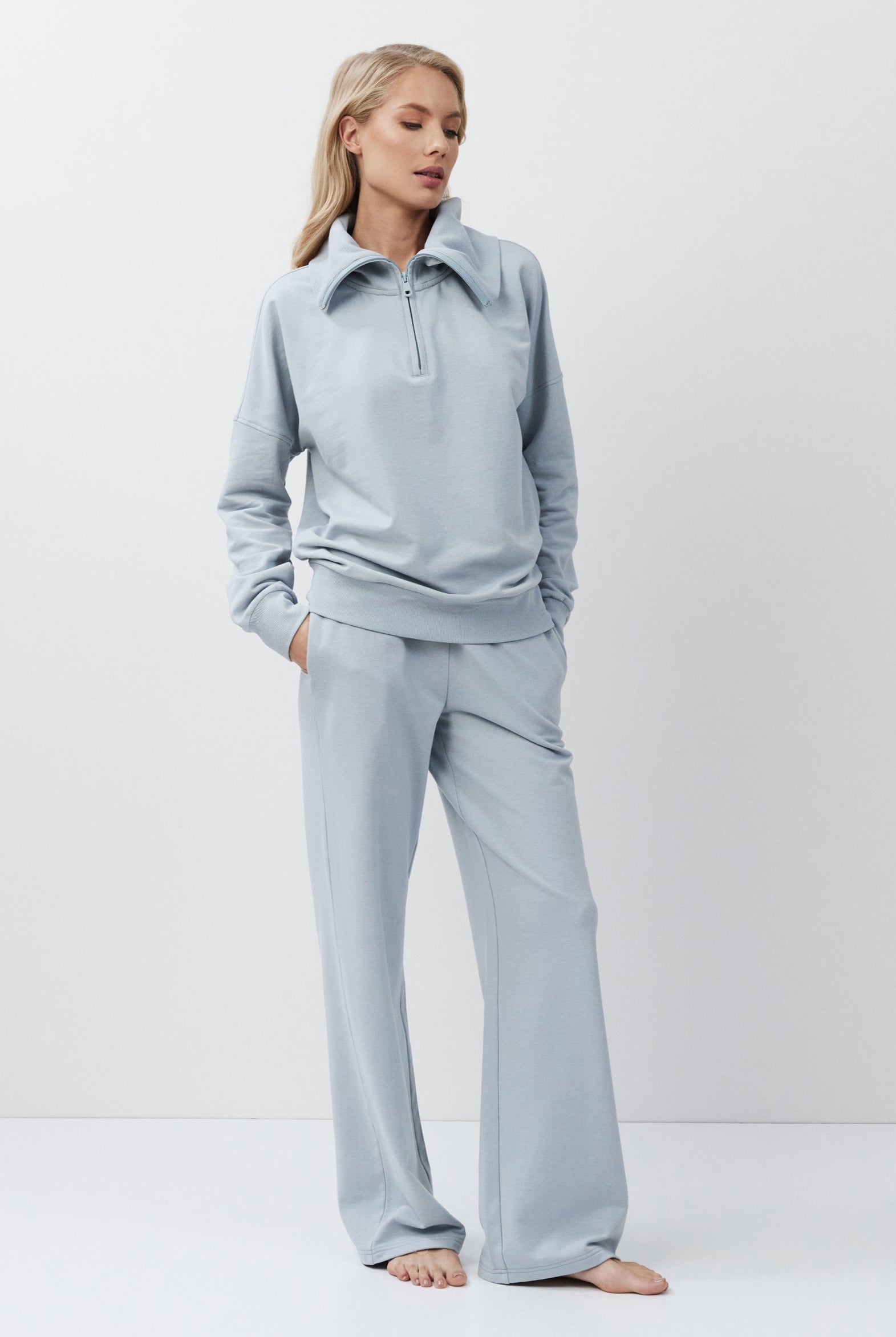 Woman wearing a blue outfit on a white background