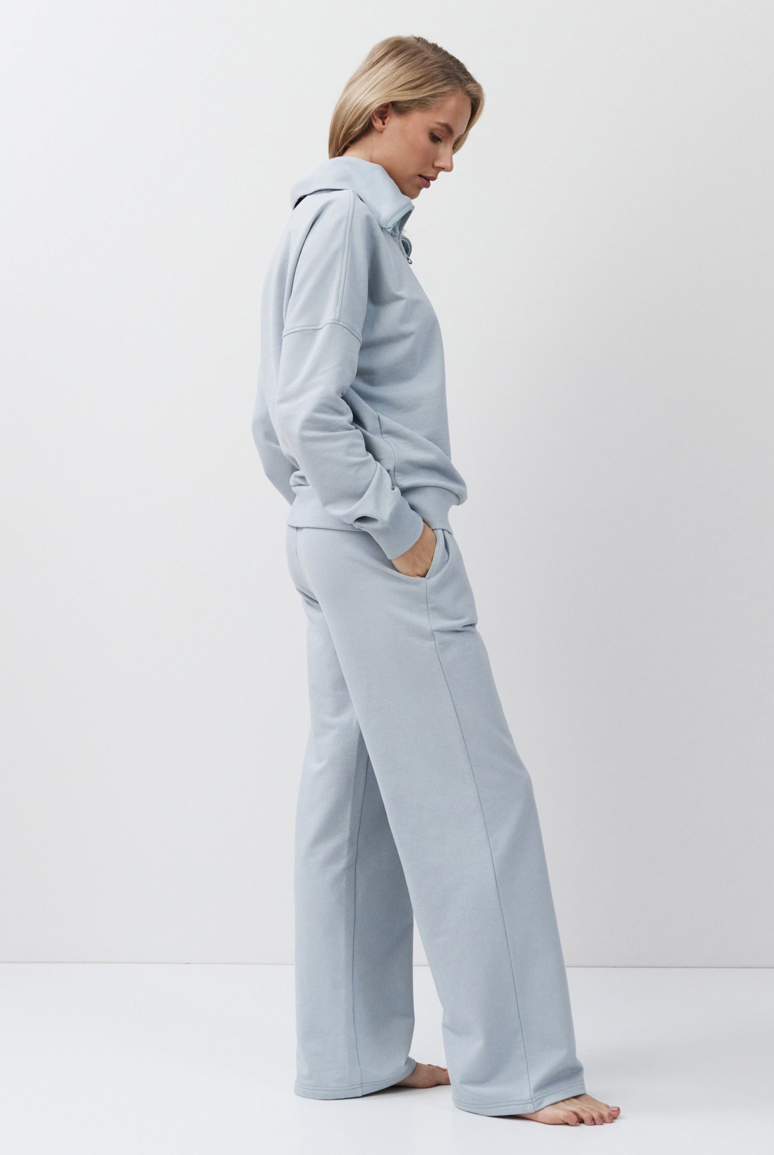 Person wearing a blue tracksuit on a white background