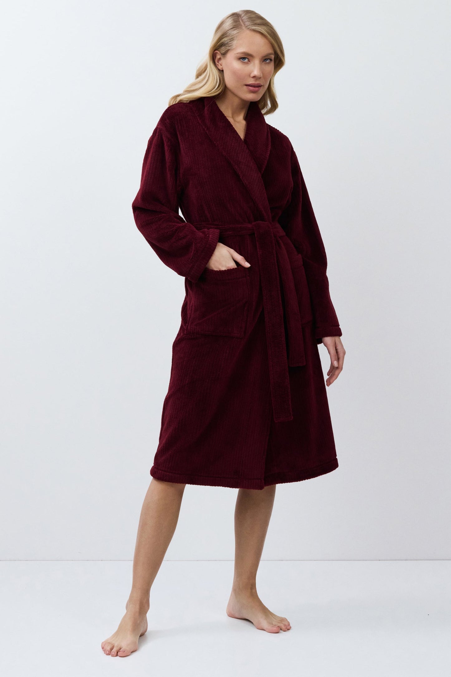 Woman wearing a burgundy robe on a white background