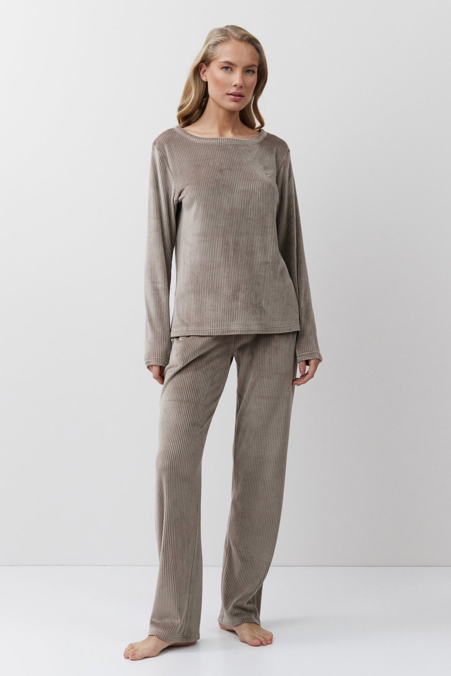 Woman wearing a capucine lounge set on a white background