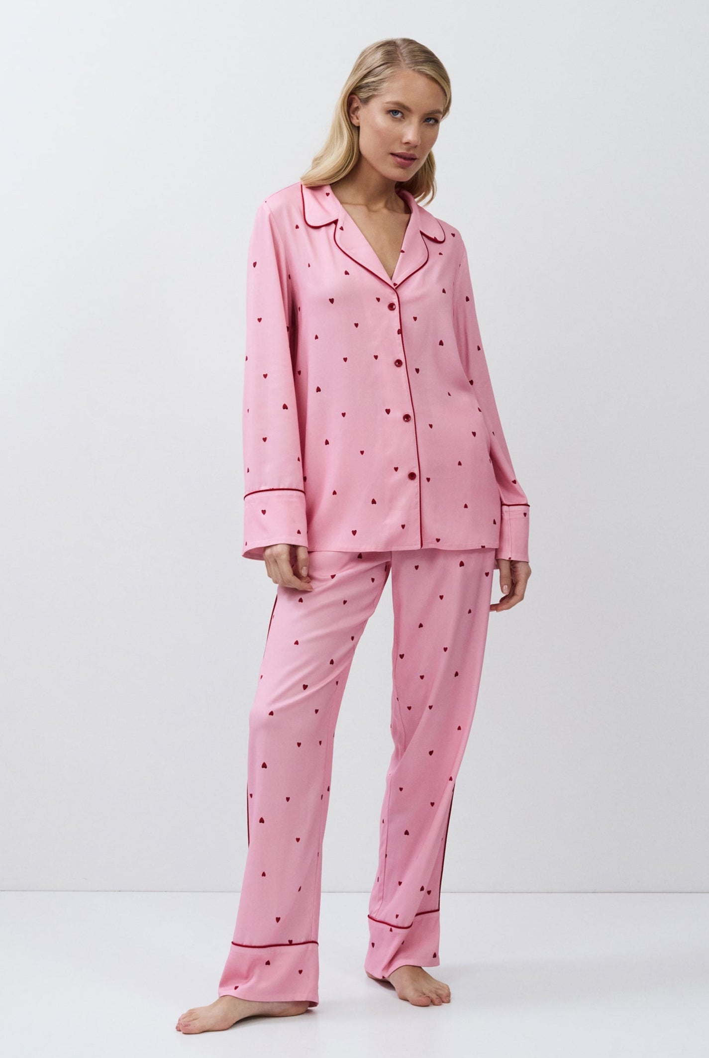 Woman wearing pink pajamas with a white background