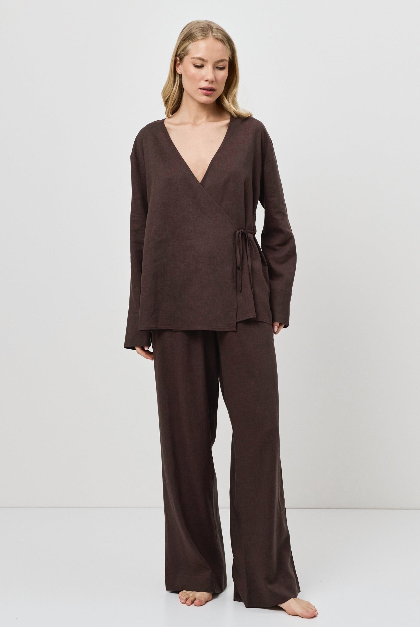 Woman wearing a brown resort wear set on a white background