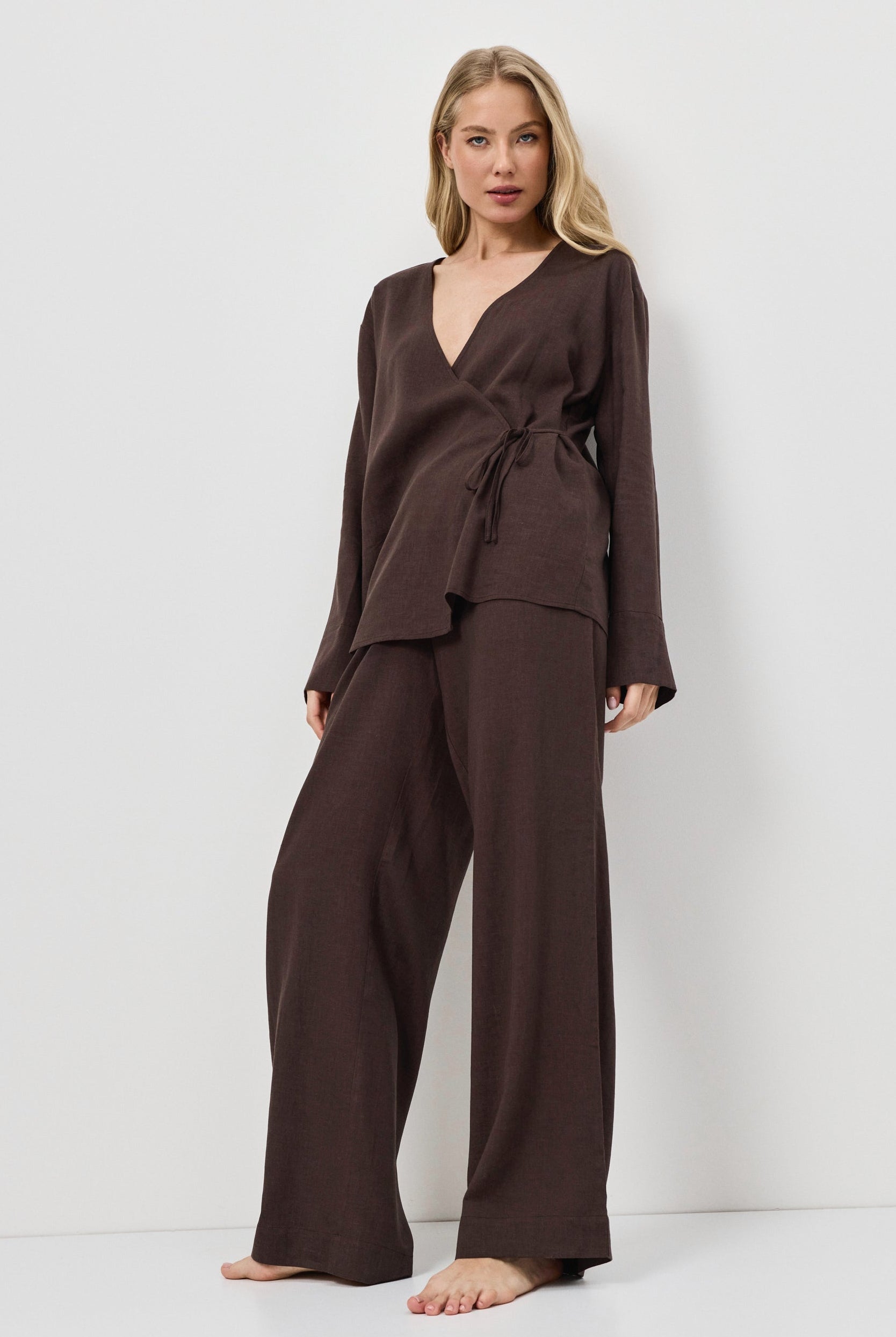 Woman wearing a brown resort wear set on a white background