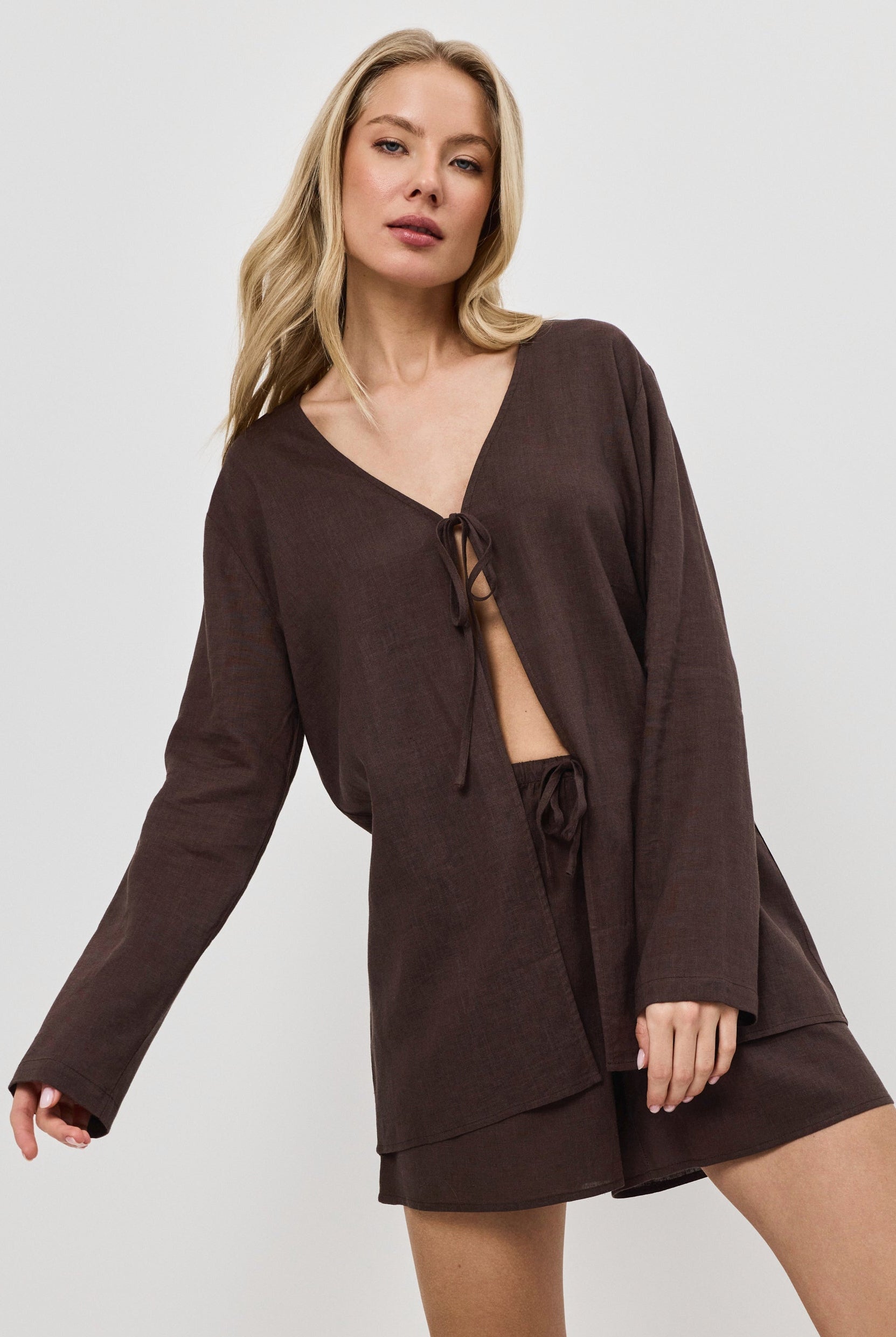 Woman wearing a brown resort wear set on a white background