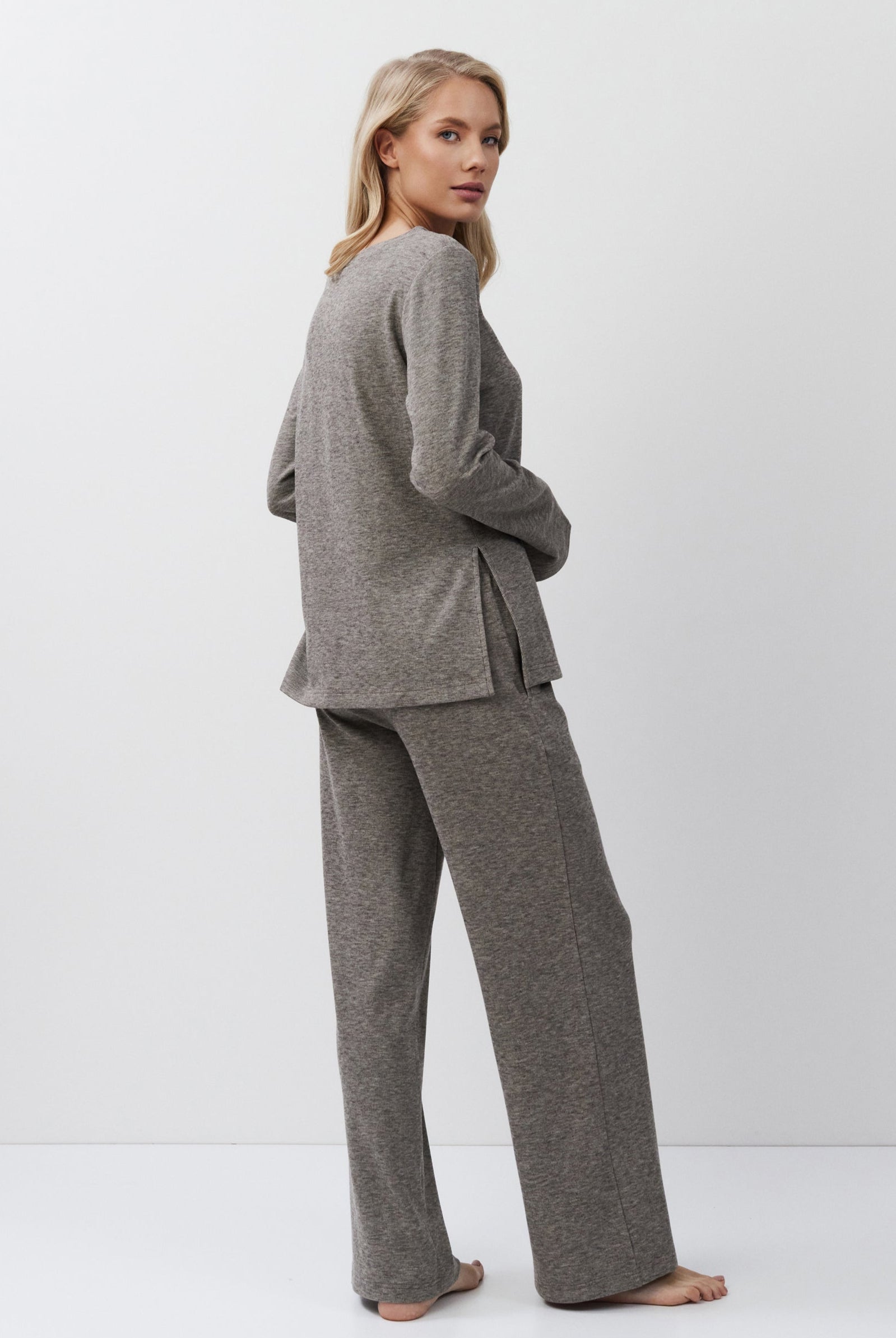 Woman wearing a brown outfit on a white background