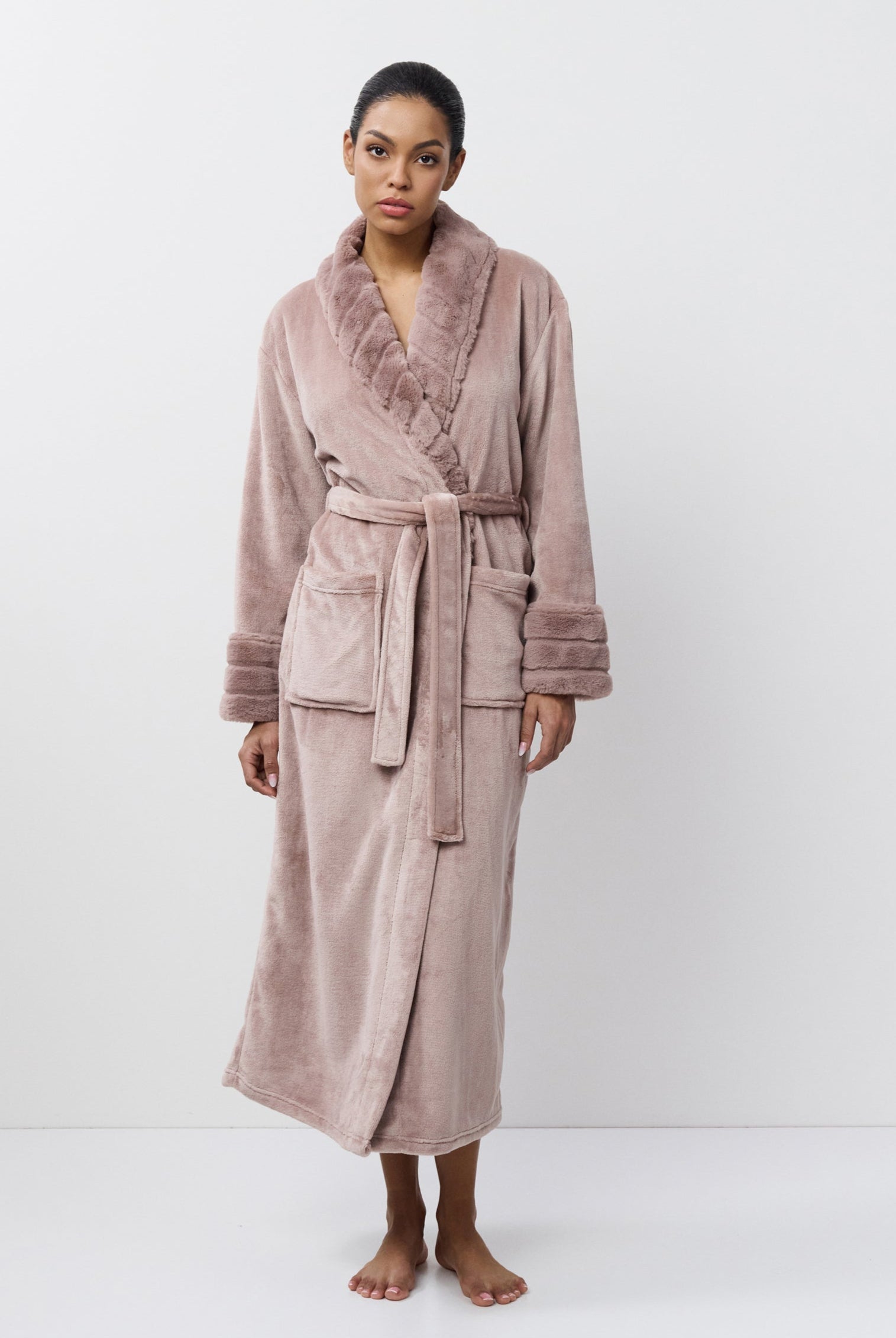 Woman wearing a pink robe on a white background