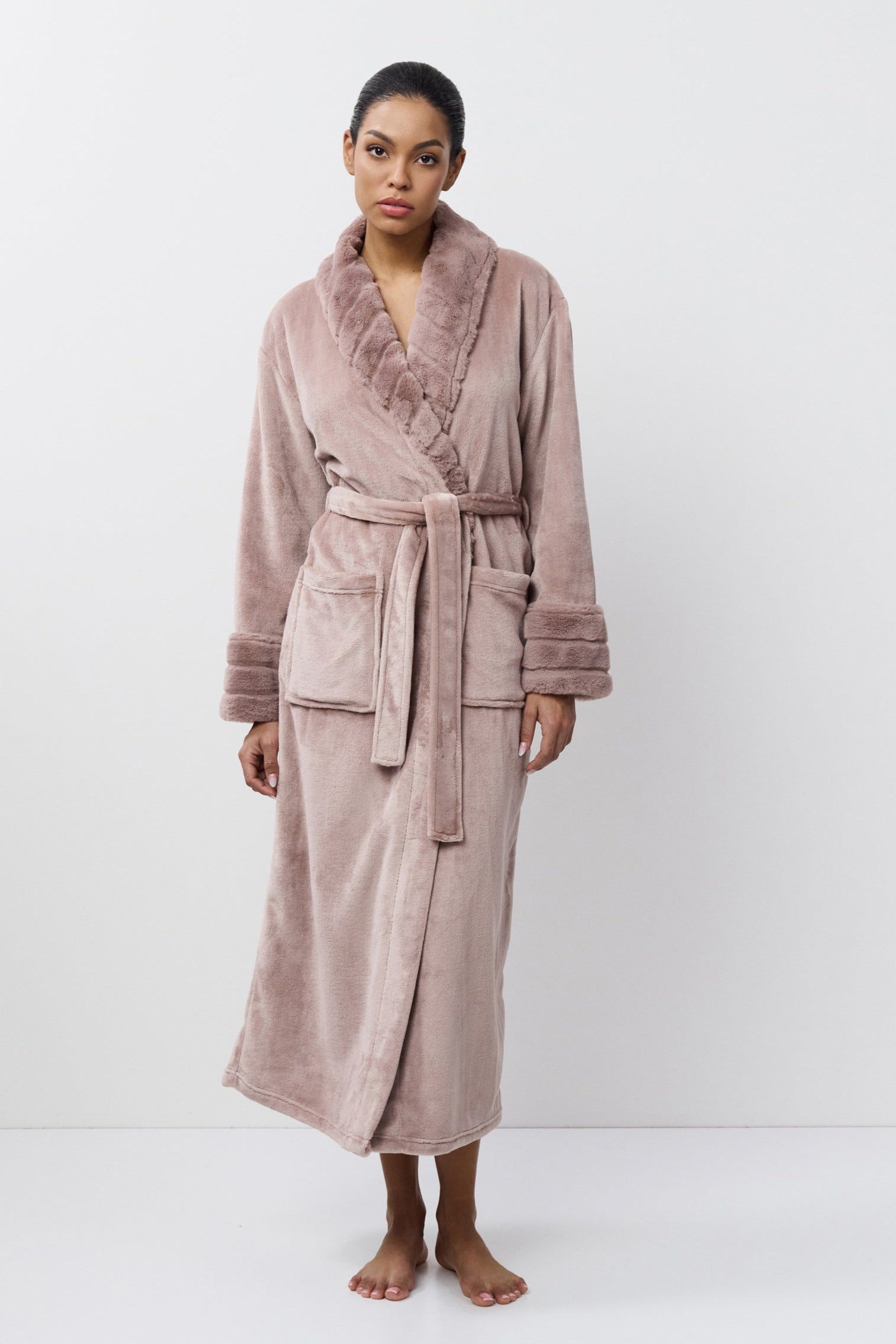 Woman wearing a pink robe on a white background