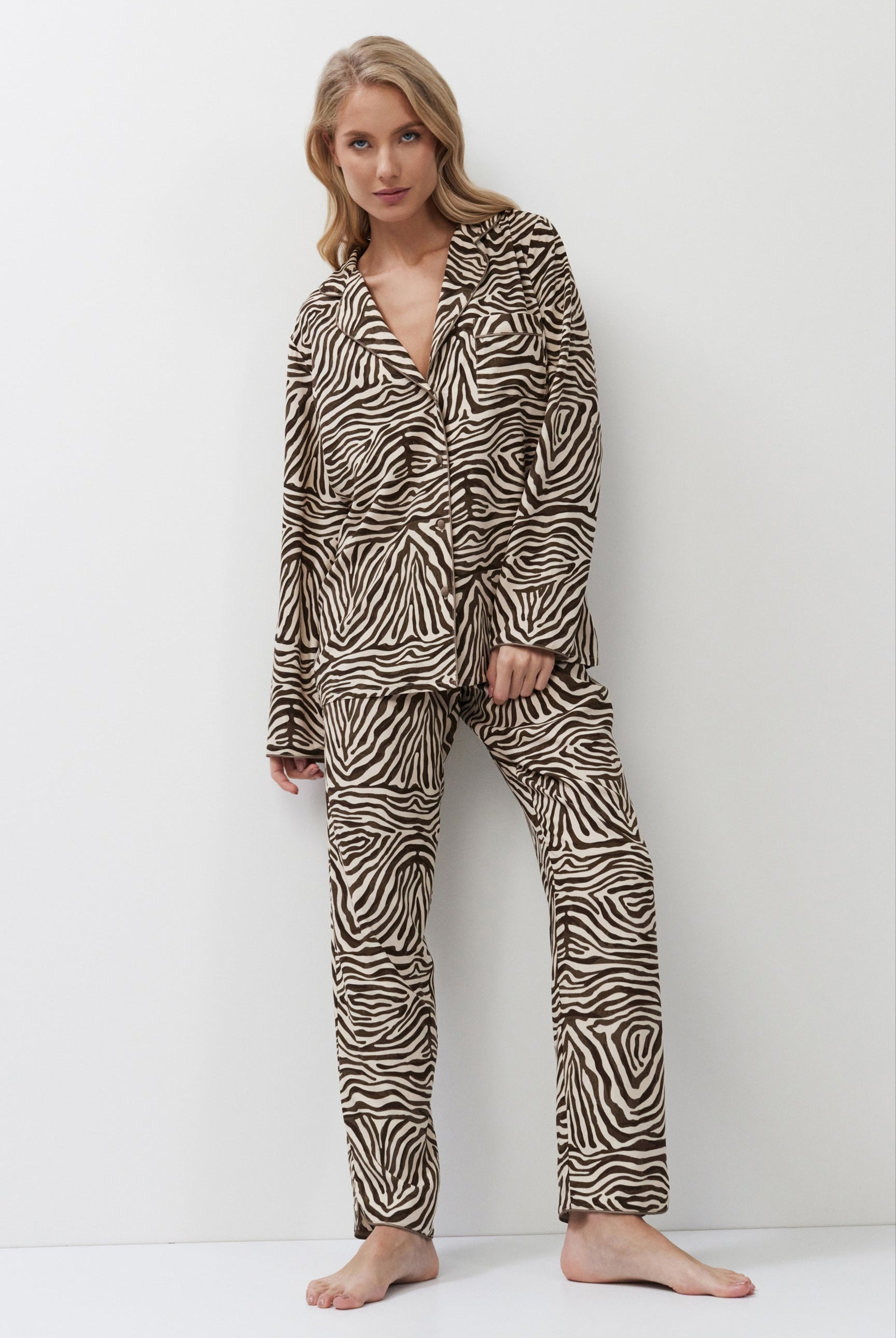 Woman wearing zebra print pajamas against a white background