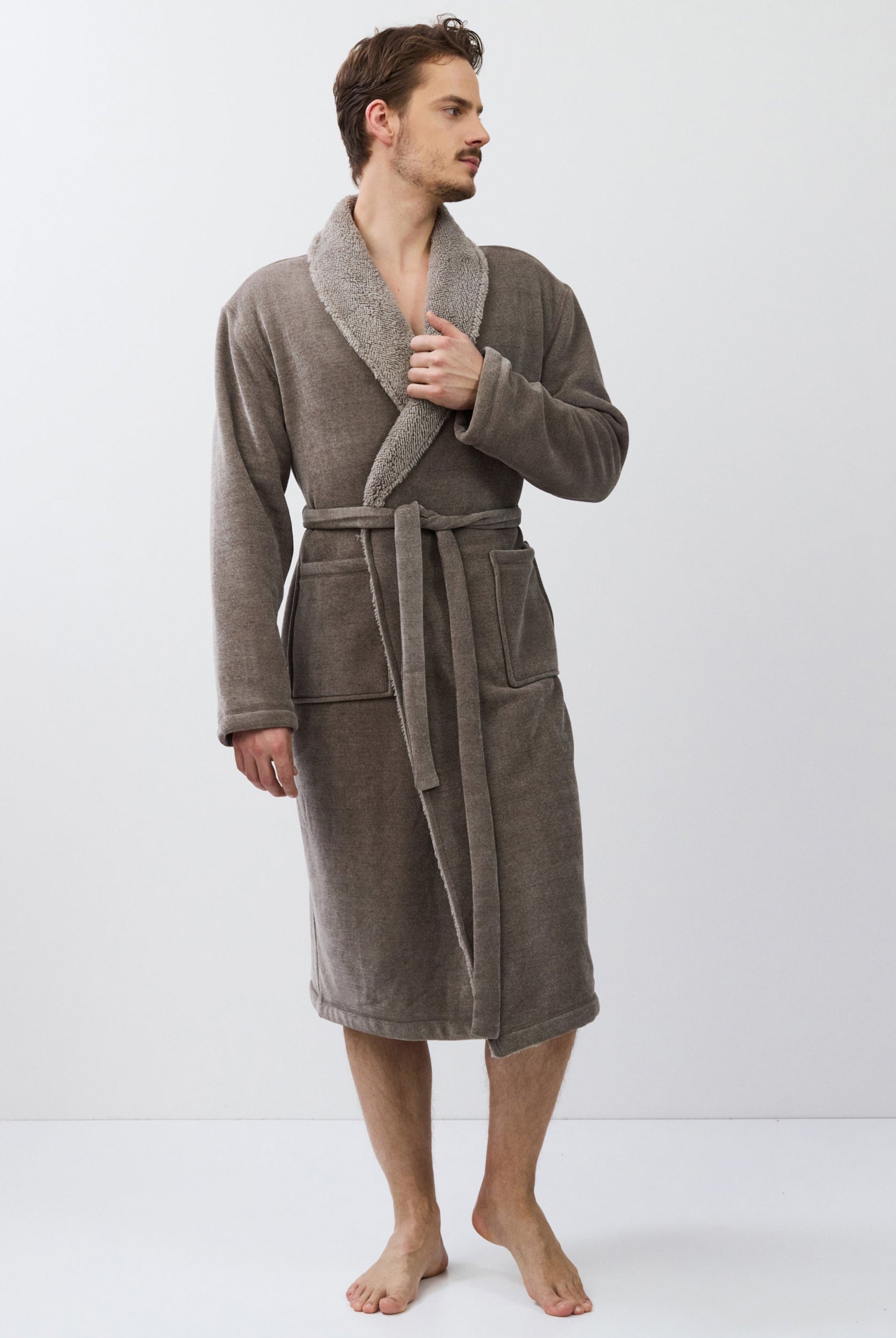 Man wearing a brown bathrobe on a white background