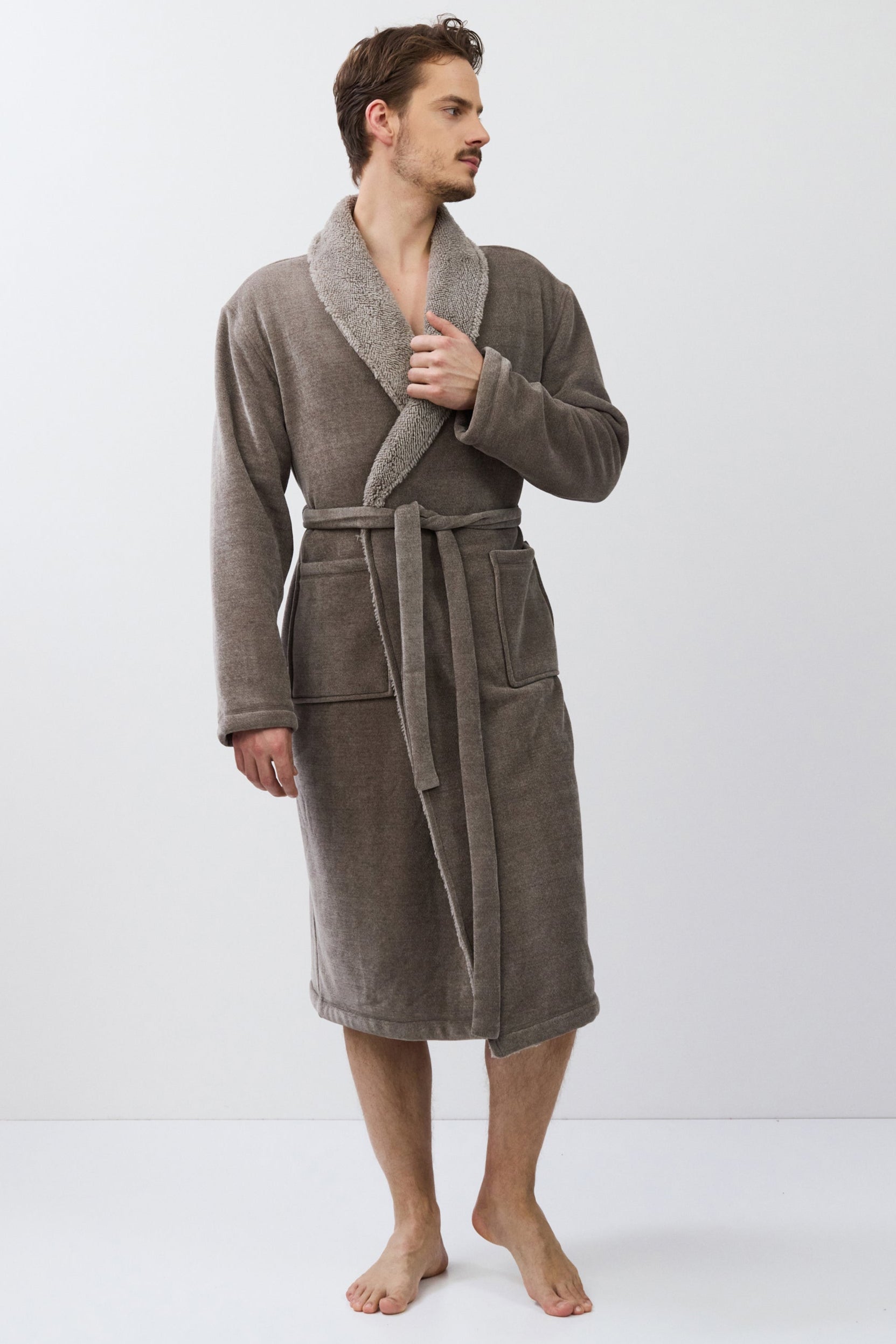 Man wearing a brown bathrobe on a white background