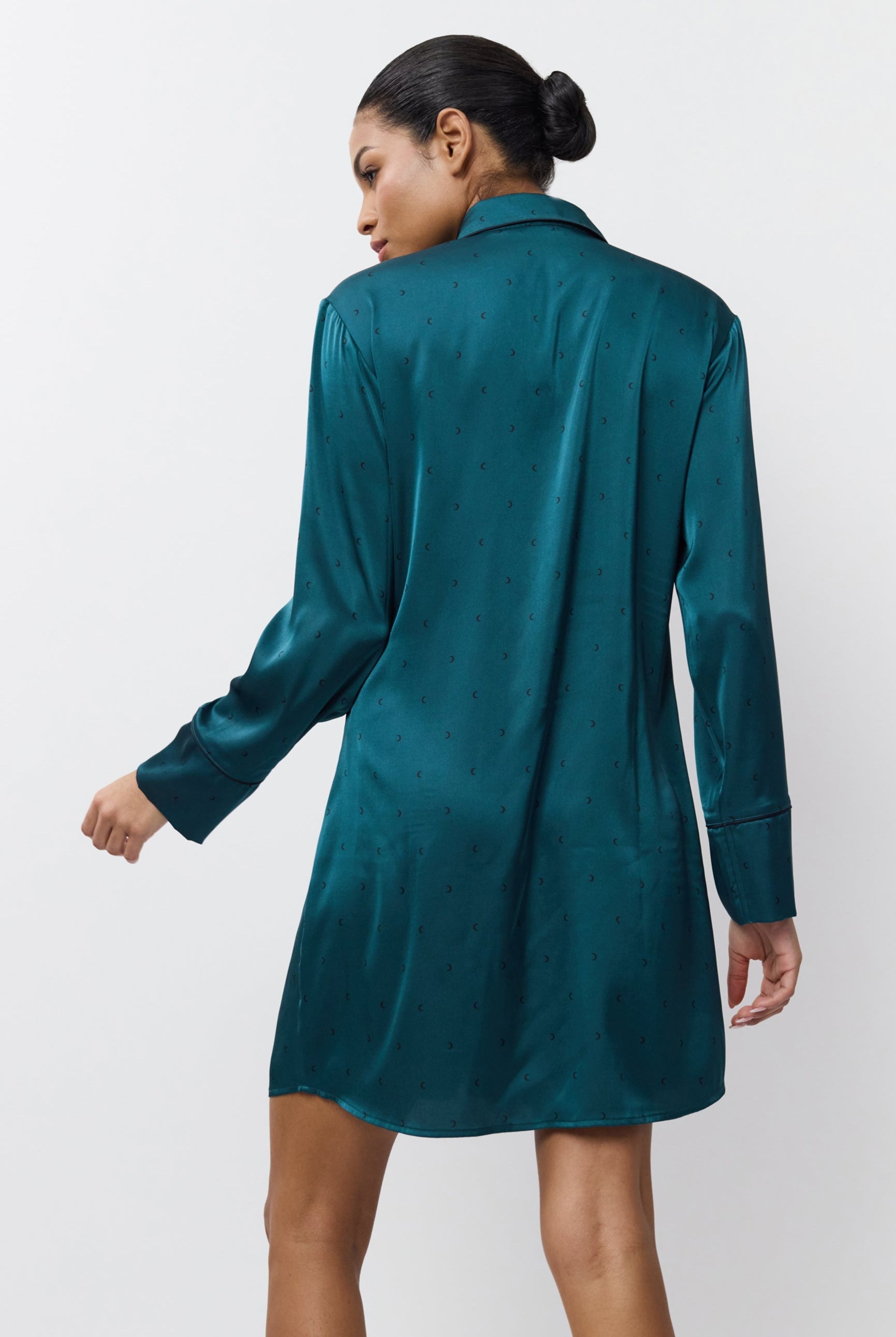 Woman wearing a satin nightdress against a white background