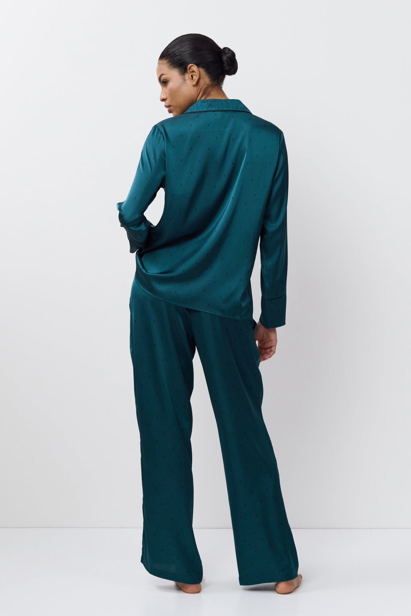 Woman wearing a pajama set on a white background