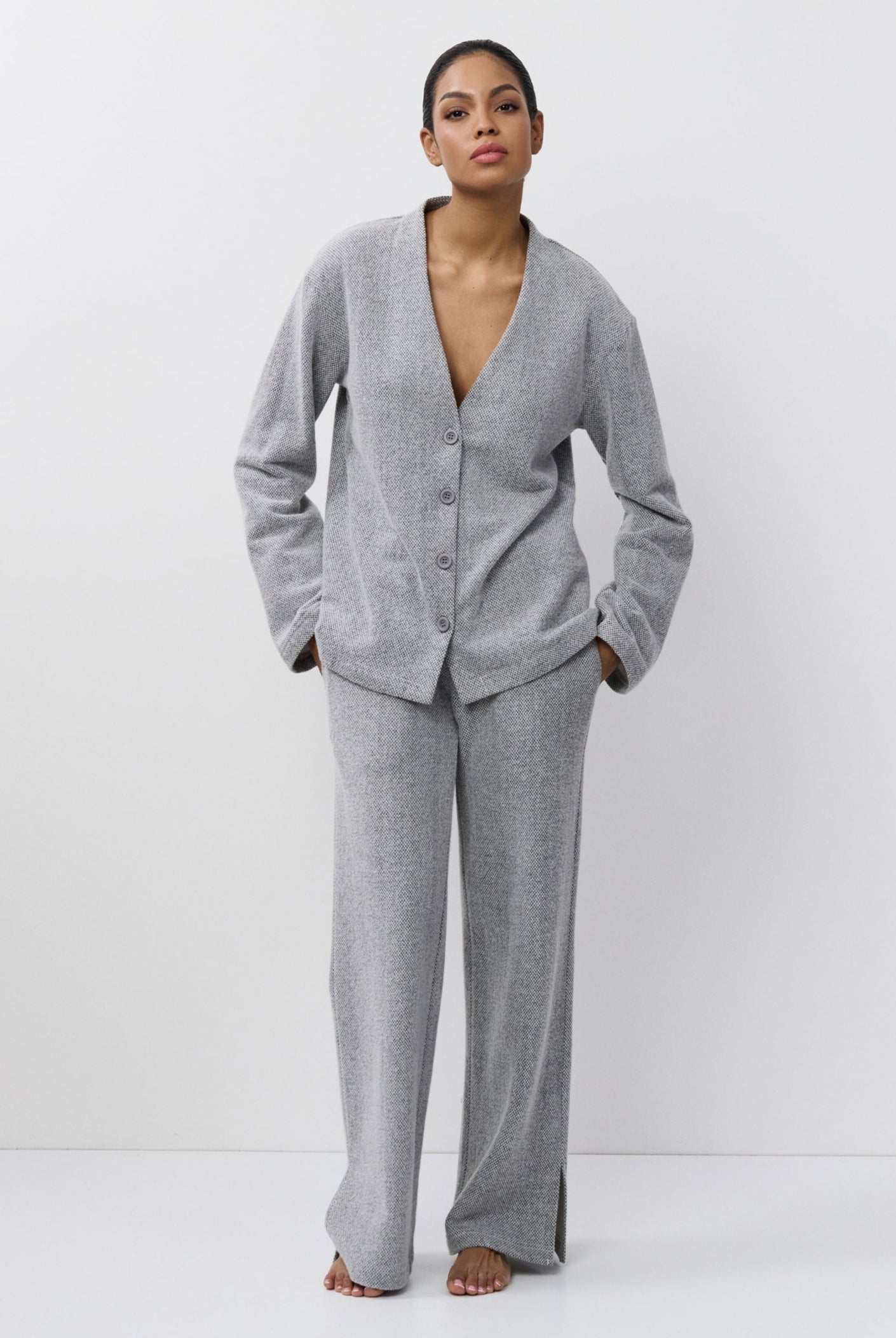 Woman wearing a gray set on a white background