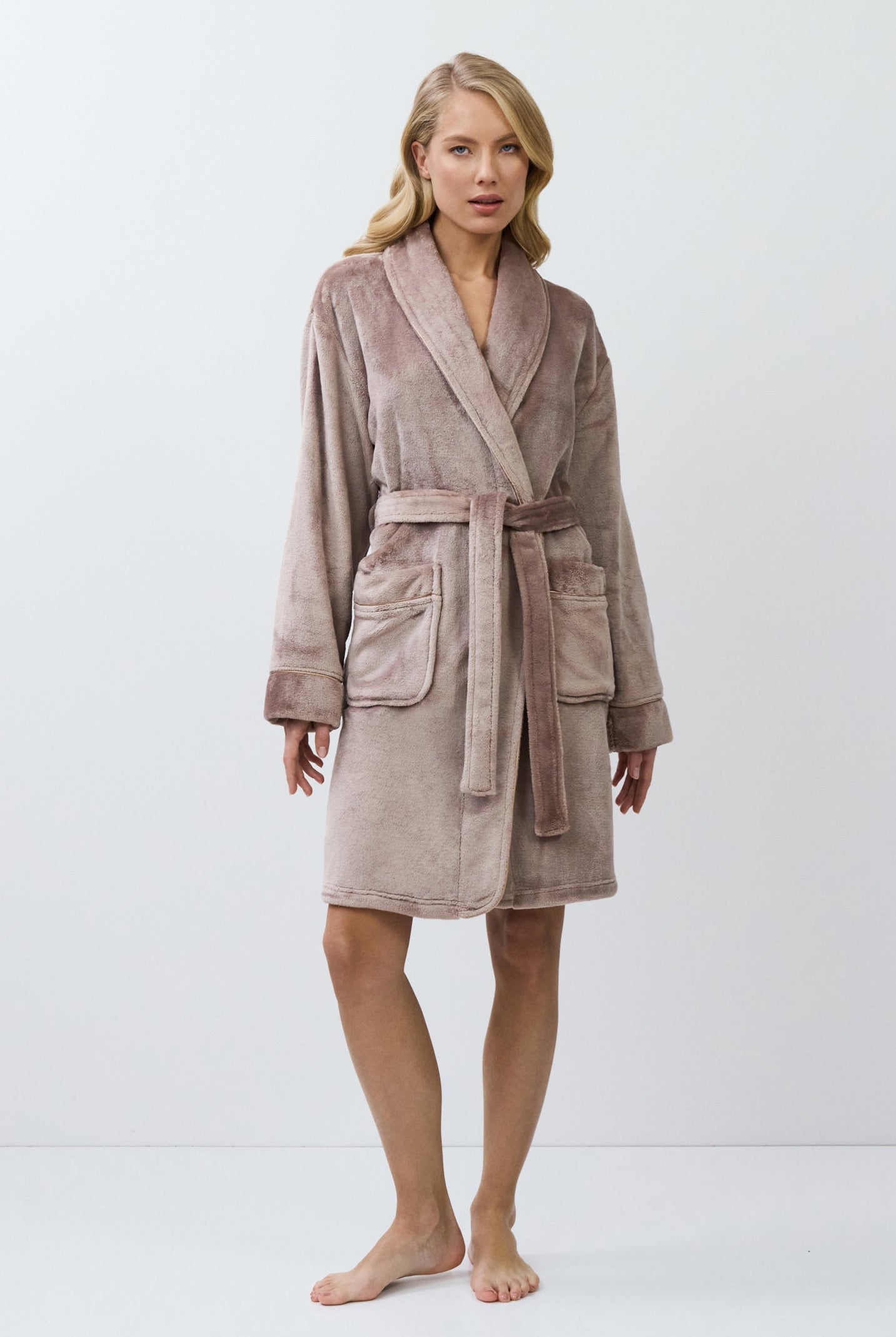 Woman wearing a choco bathrobe against a white background