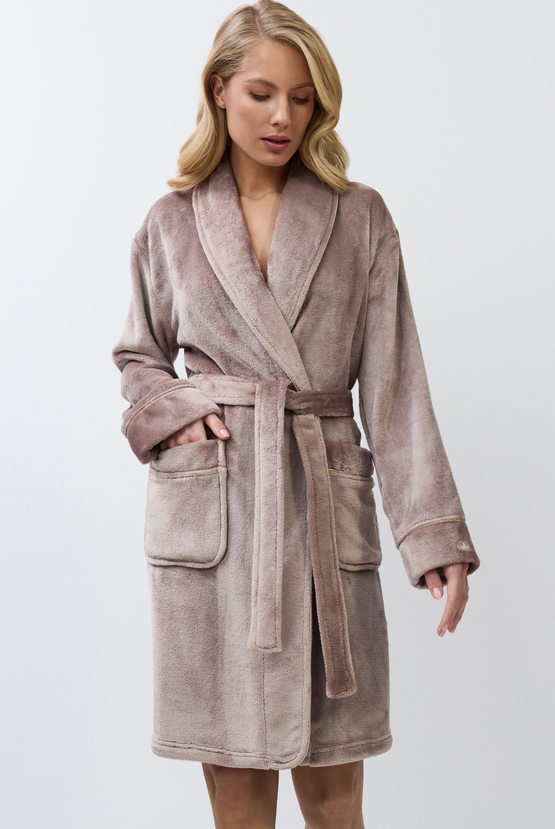 Woman wearing a choco bathrobe against a white background