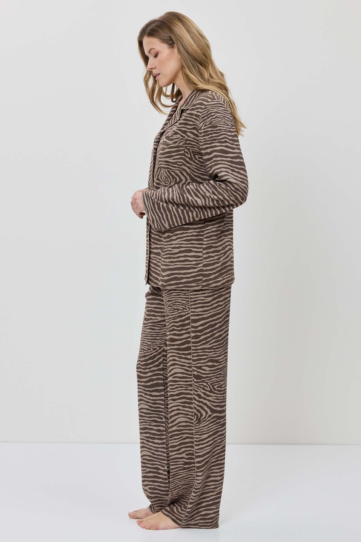 Woman wearing a zebra print outfit on a white background