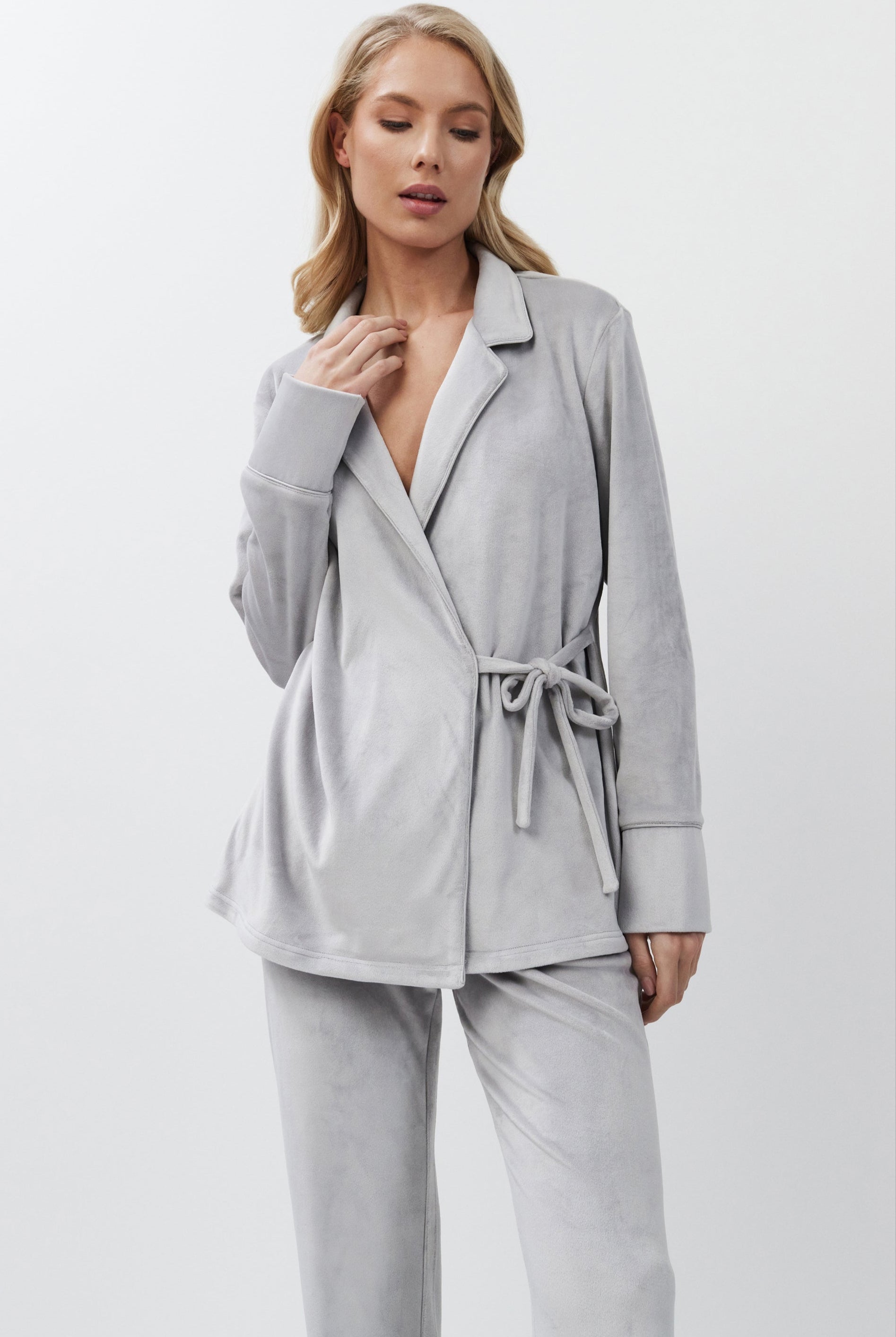 Woman wearing a light gray set on a white background