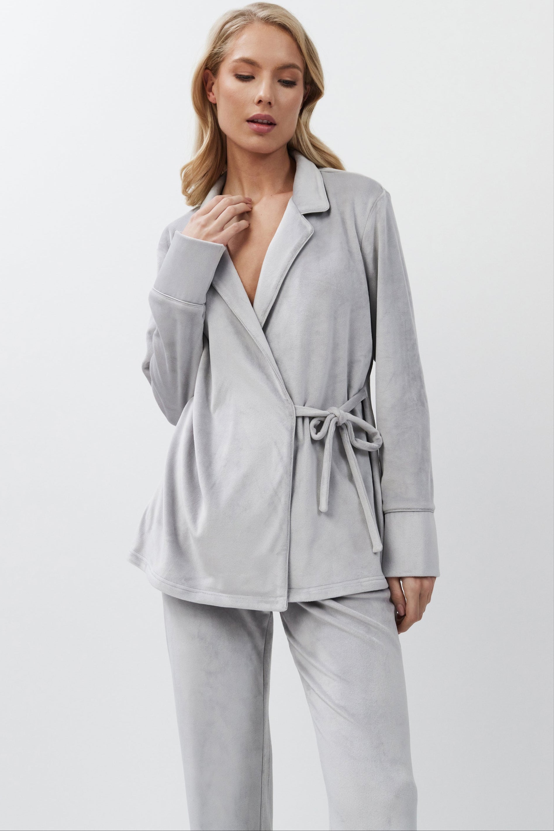 Woman wearing a light gray set on a white background