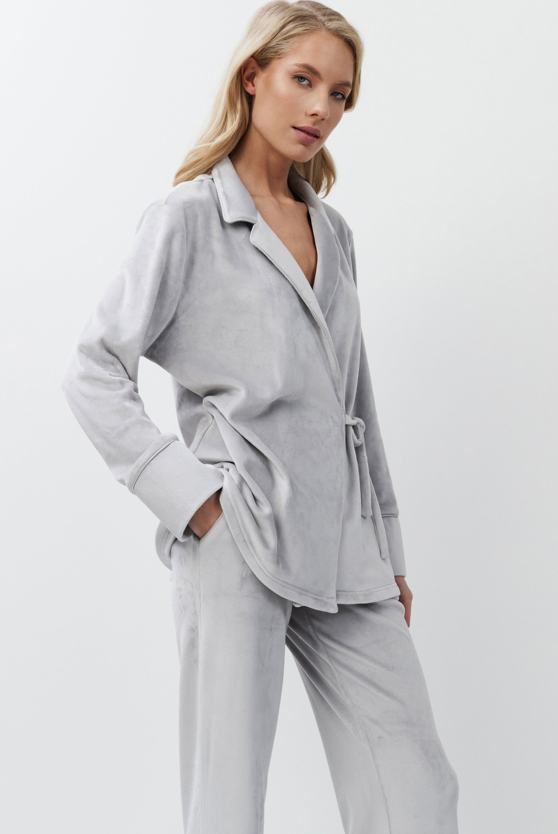 Woman wearing a light gray set on a white background