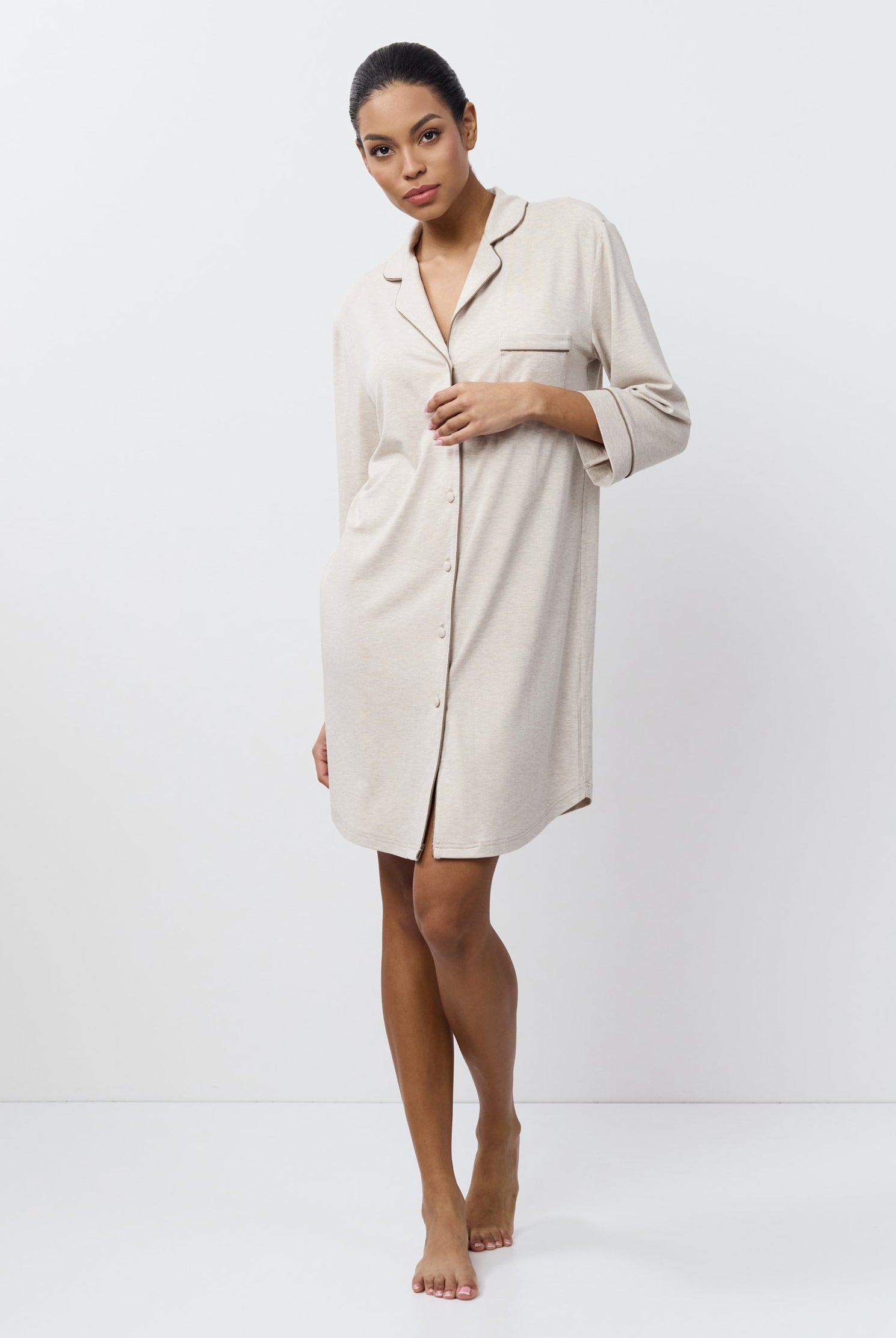 Woman wearing a beige nightdress against a white background