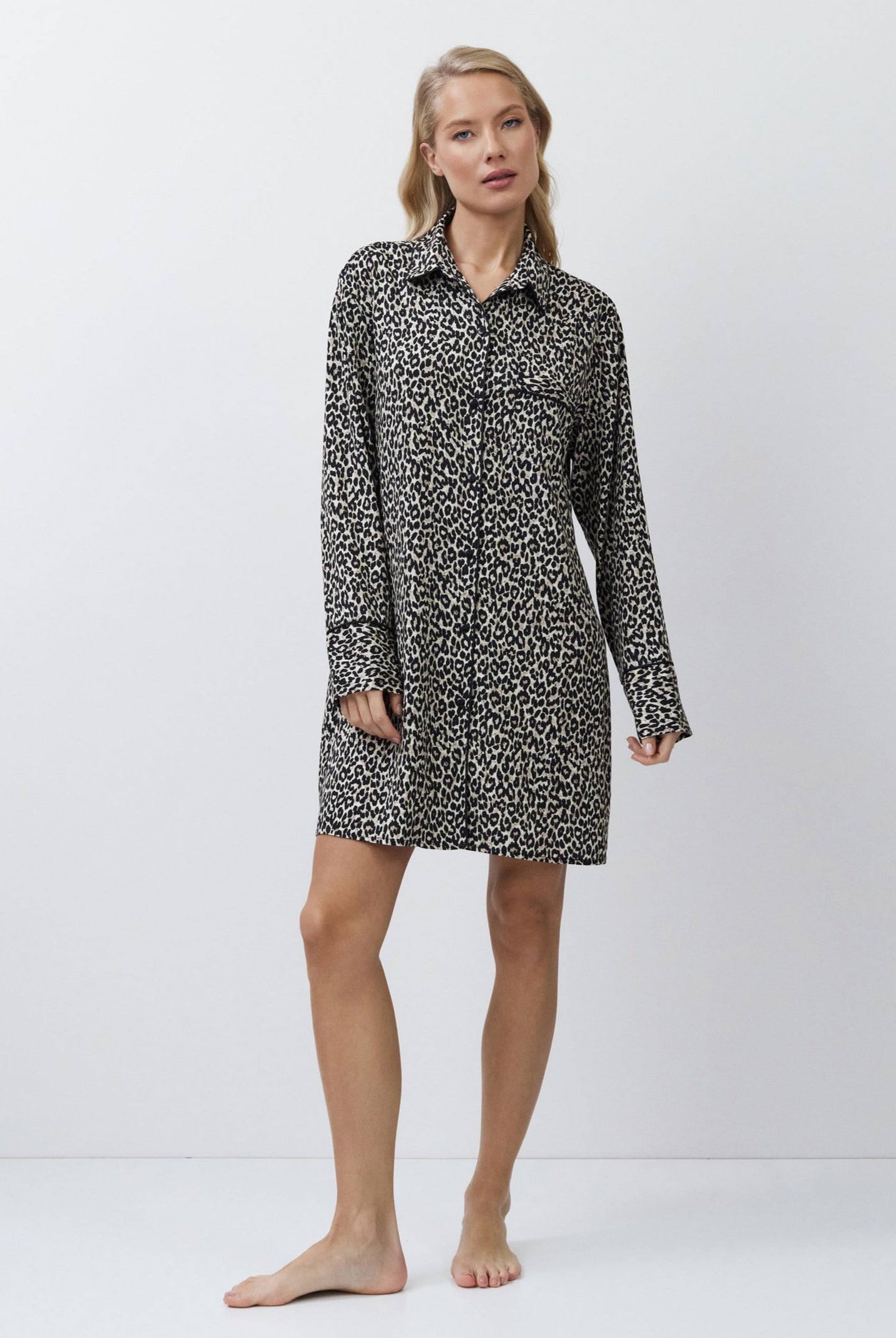 Woman wearing a patterned shirt nightdress on a white background