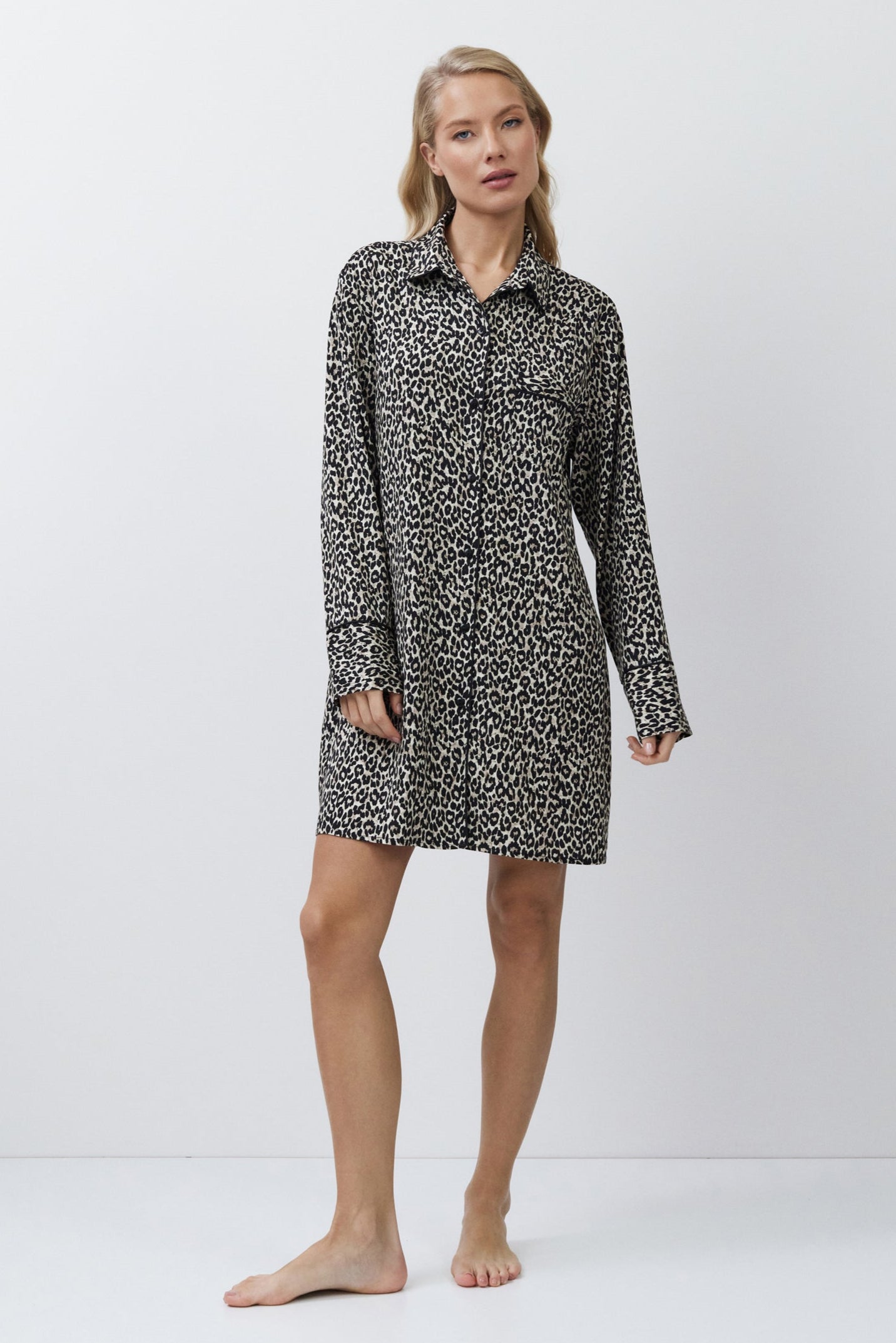 Woman wearing a patterned shirt nightdress on a white background