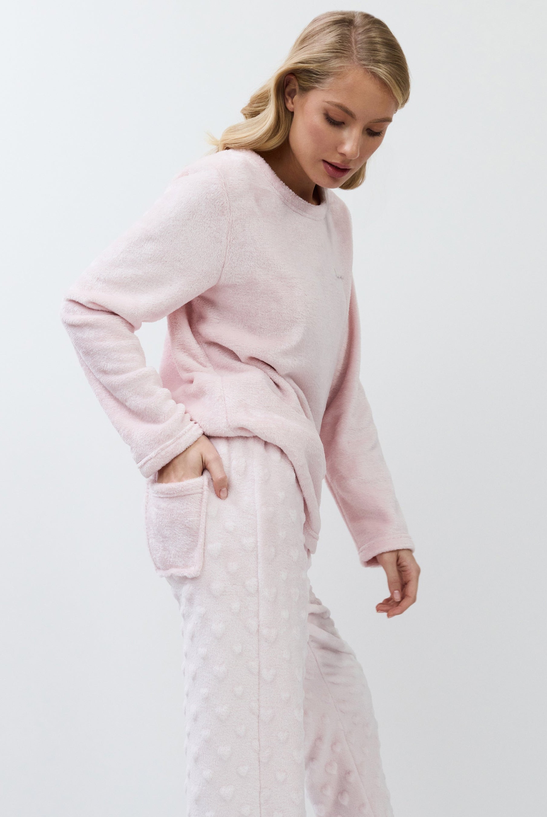 Woman wearing a pink set on a white background