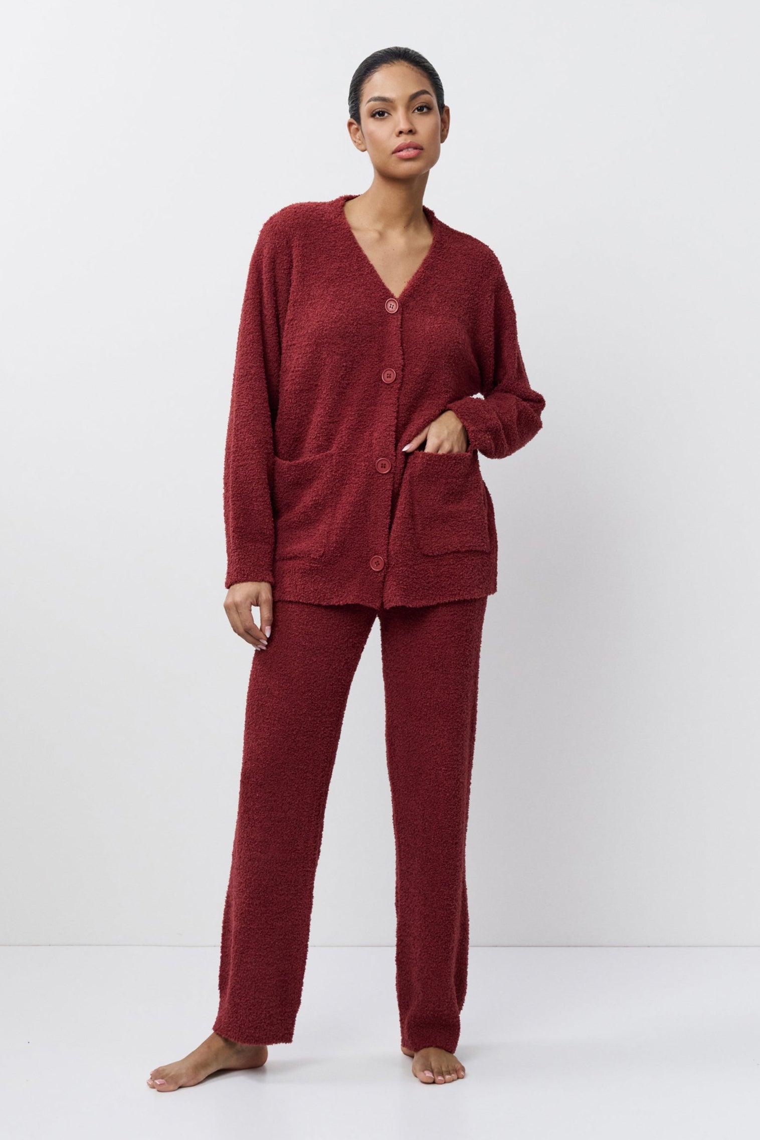 Woman wearing a red loungewear set on a white background