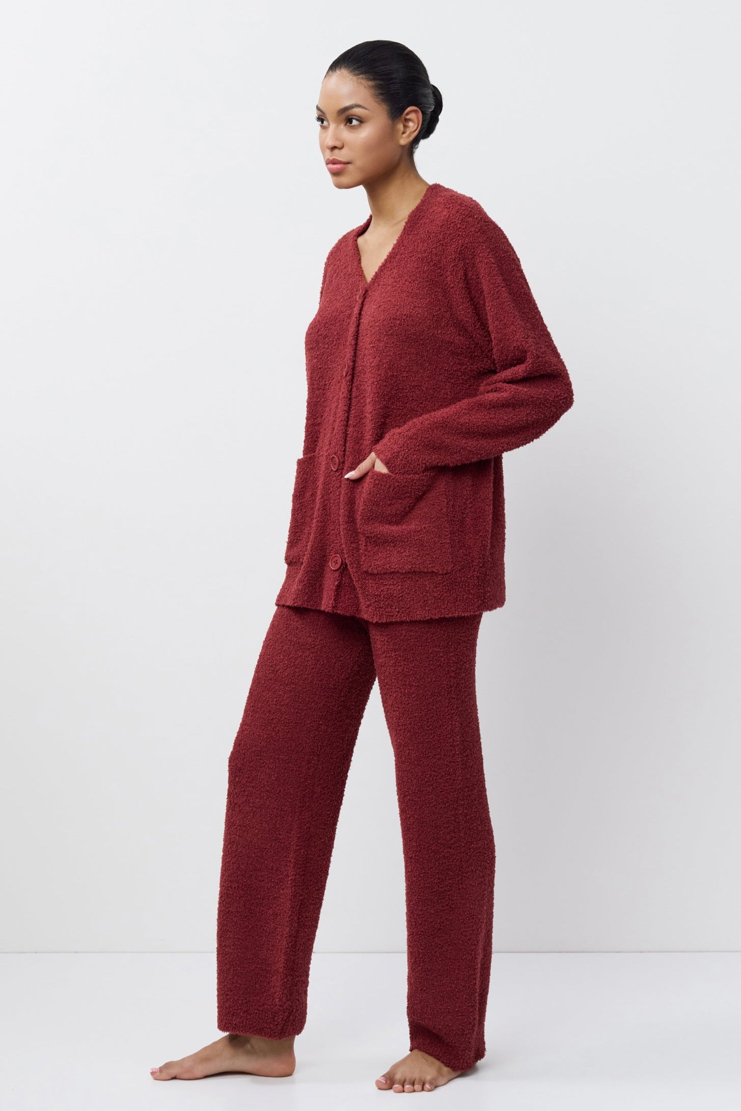 Woman wearing a red loungewear set on a white background