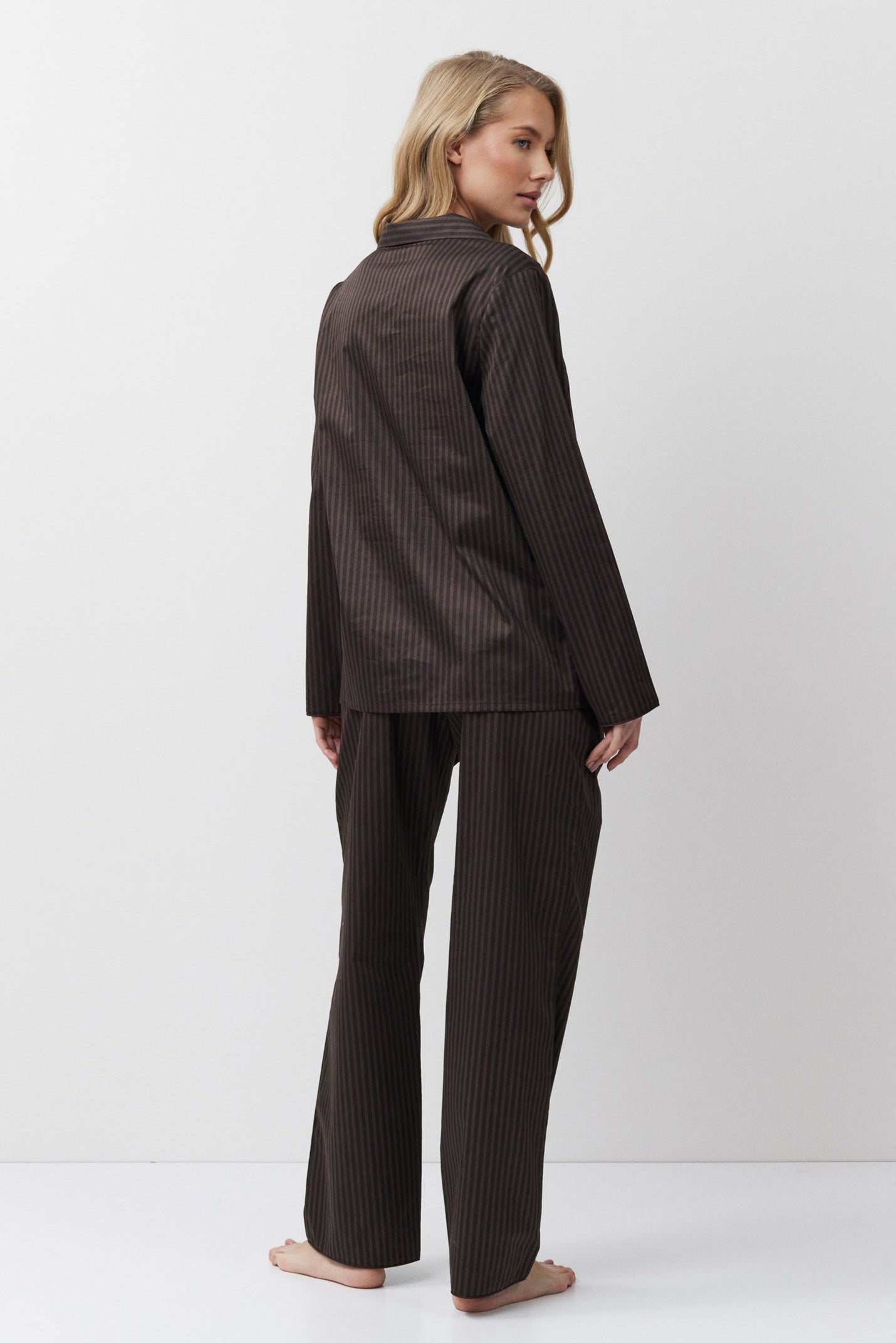 Woman wearing a brown set on a white background