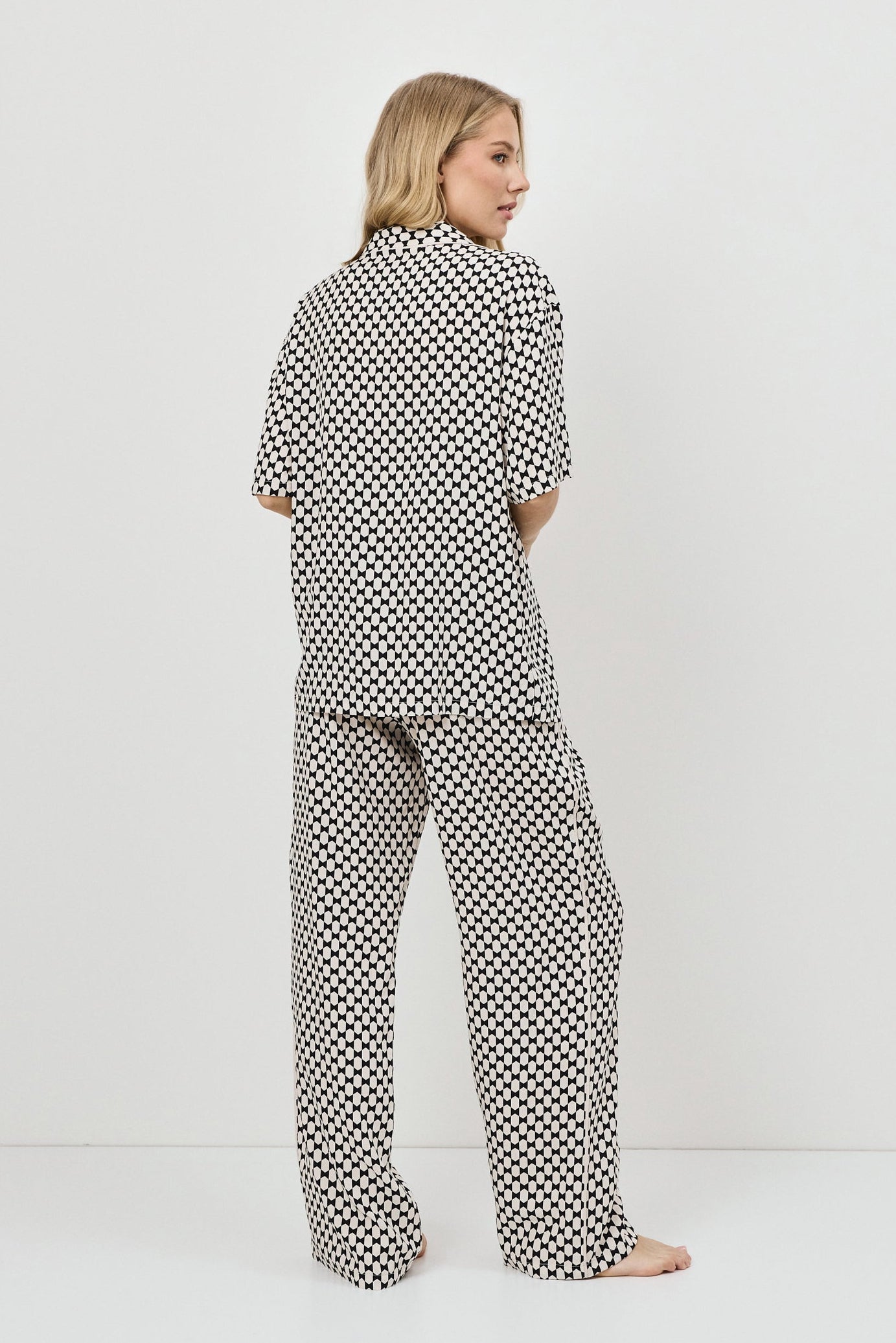 Woman wearing a pajama set on a white background