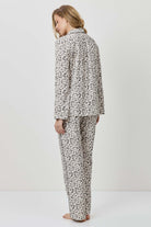 Person wearing a patterned pajama set on a white background