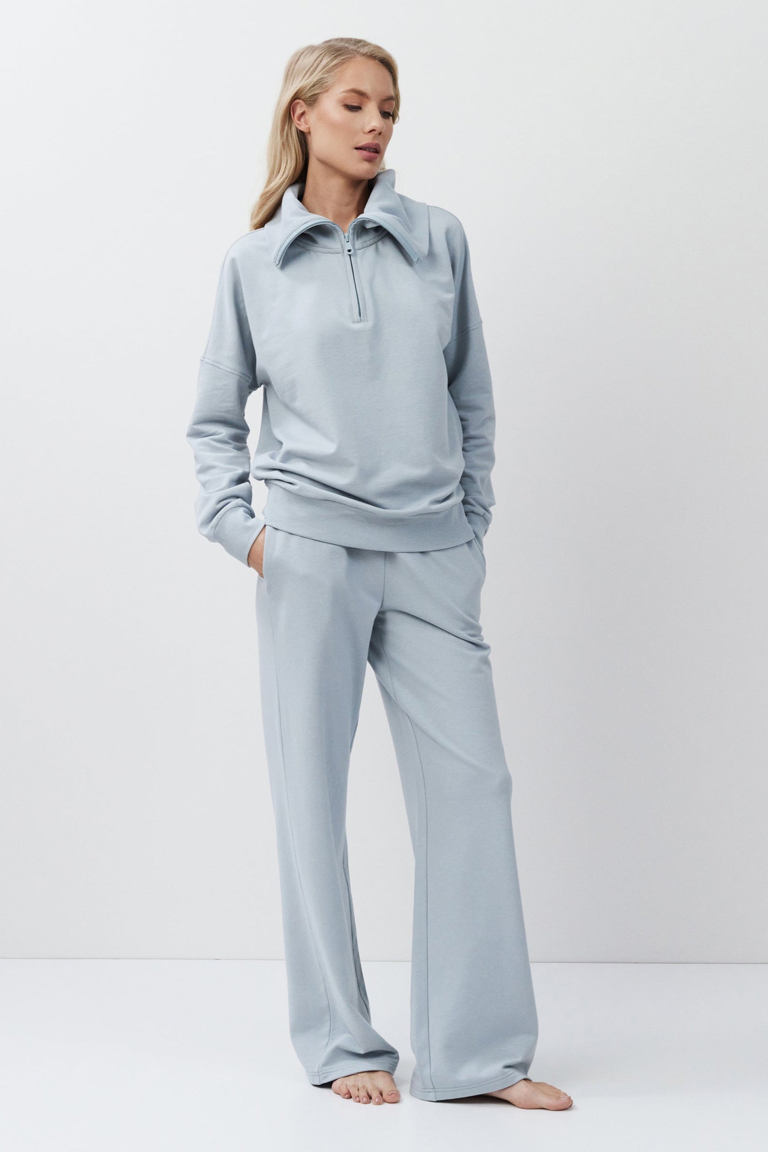 Woman wearing a blue outfit on a white background