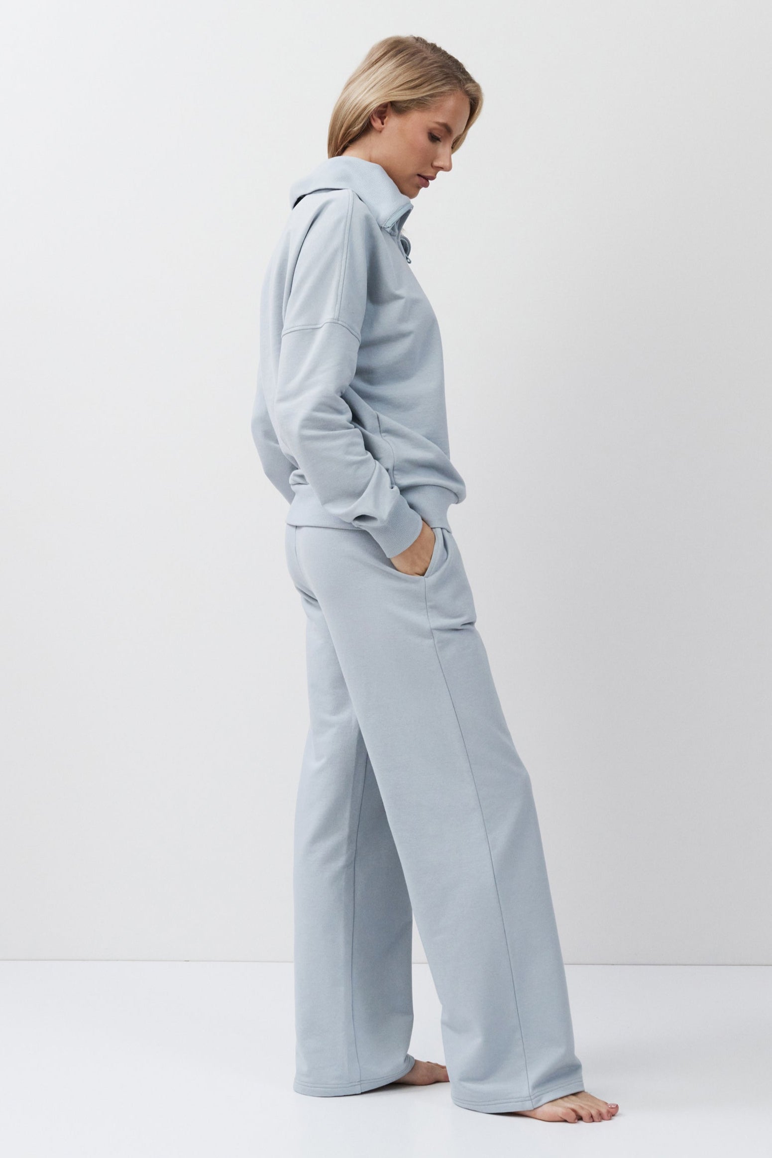 Person wearing a blue tracksuit on a white background