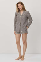 Woman wearing a striped pajama set on a white background