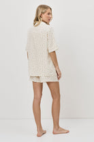 Woman wearing a pajama set on a white background