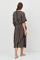 Woman wearing a striped dress on a white background