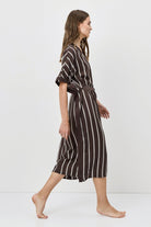 Woman wearing a striped dress on a white background