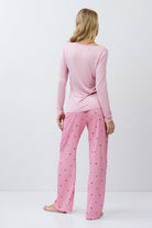 Woman wearing pink pajamas on a white background