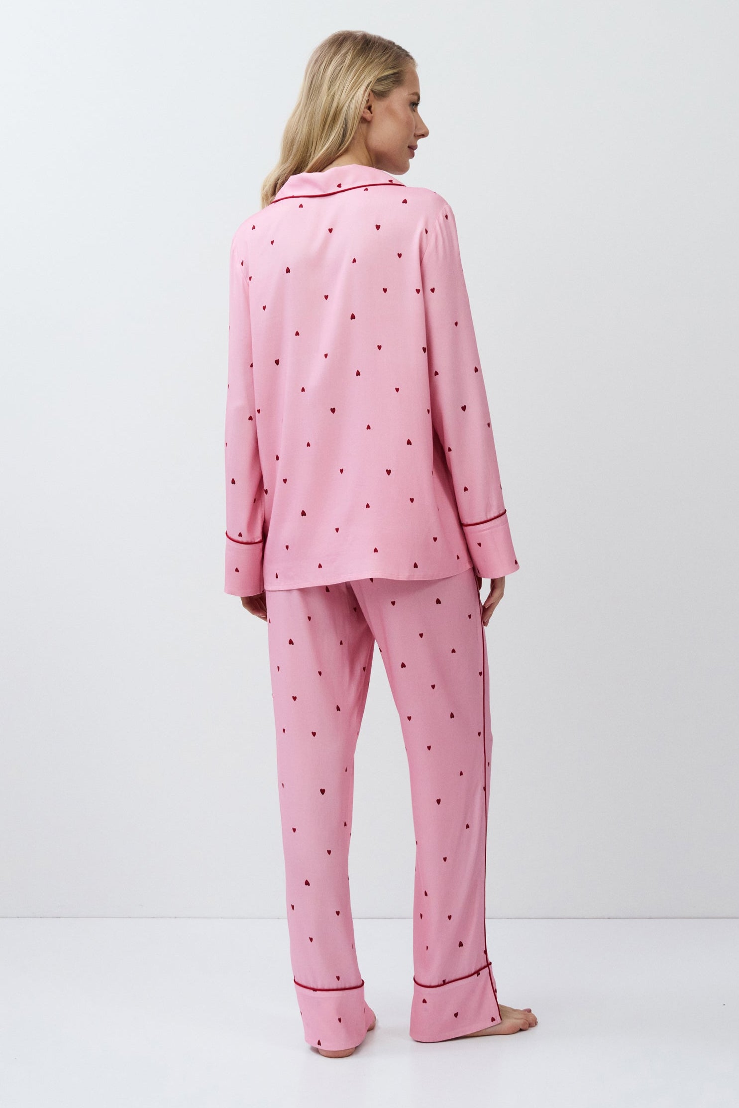 Person wearing pink pajamas on a white background