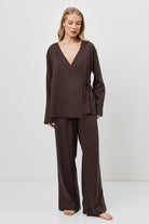 Woman wearing a brown resort wear set on a white background