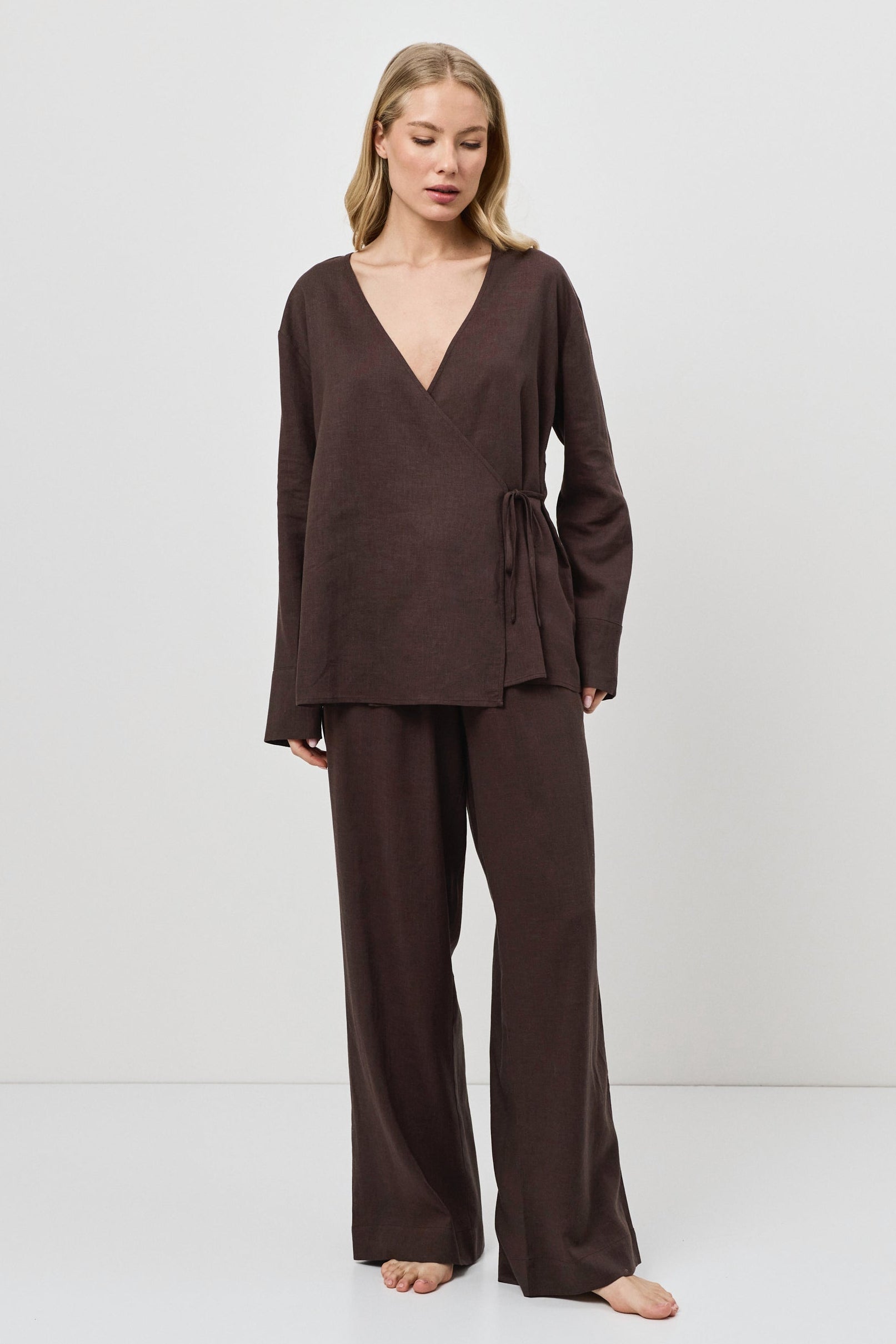 Woman wearing a brown resort wear set on a white background