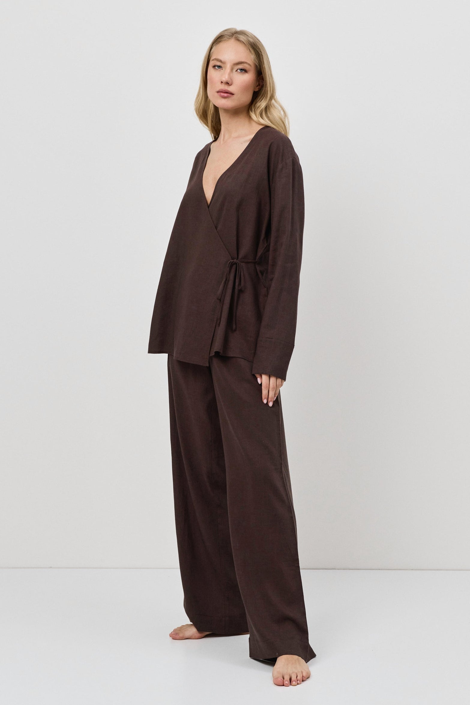 Woman wearing a brown resort wear set on a white background