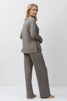 Woman wearing a brown outfit on a white background