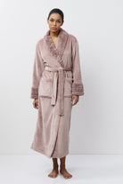 Woman wearing a pink robe on a white background